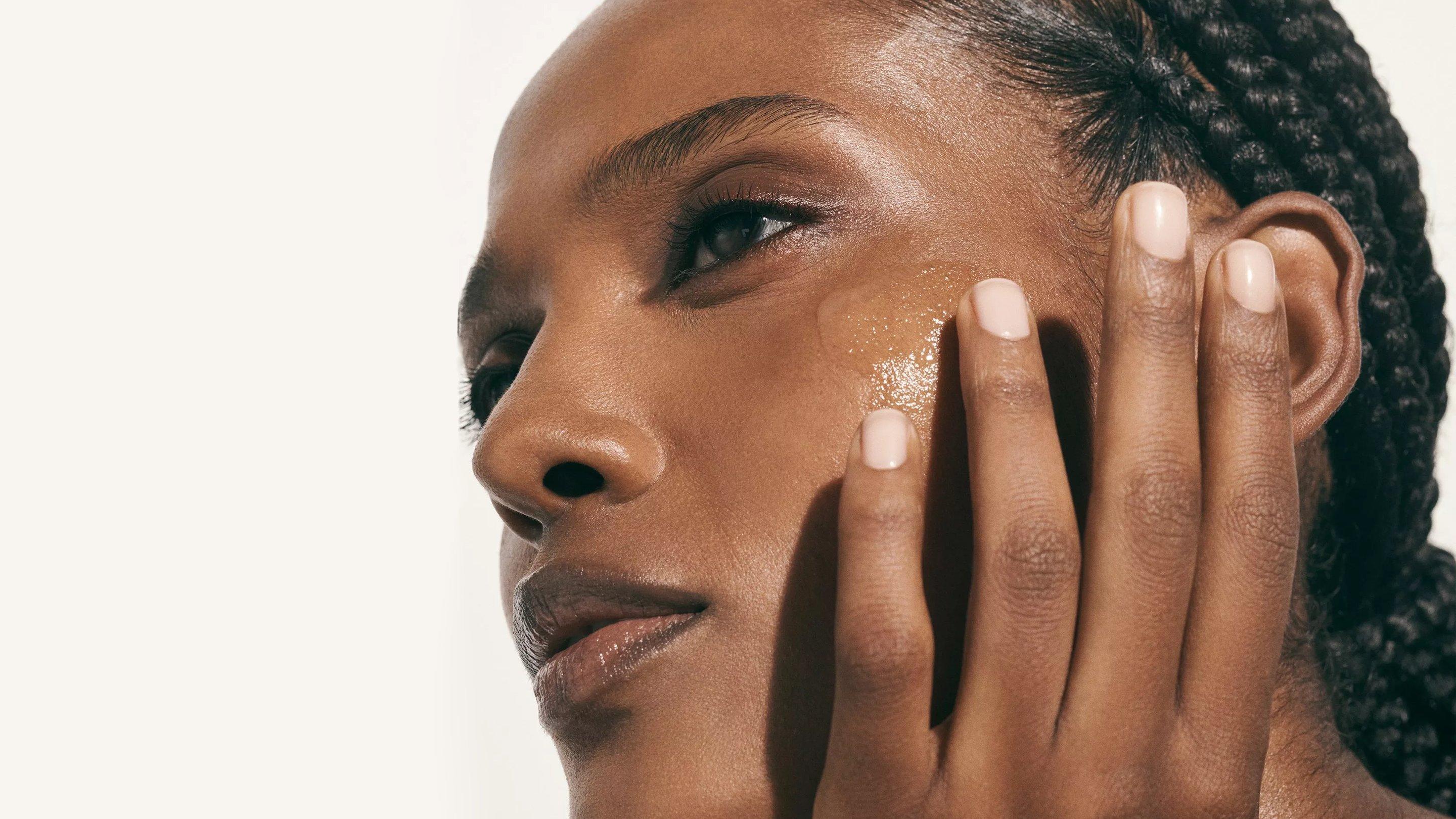 Image of a model wiping moisturiser on her face