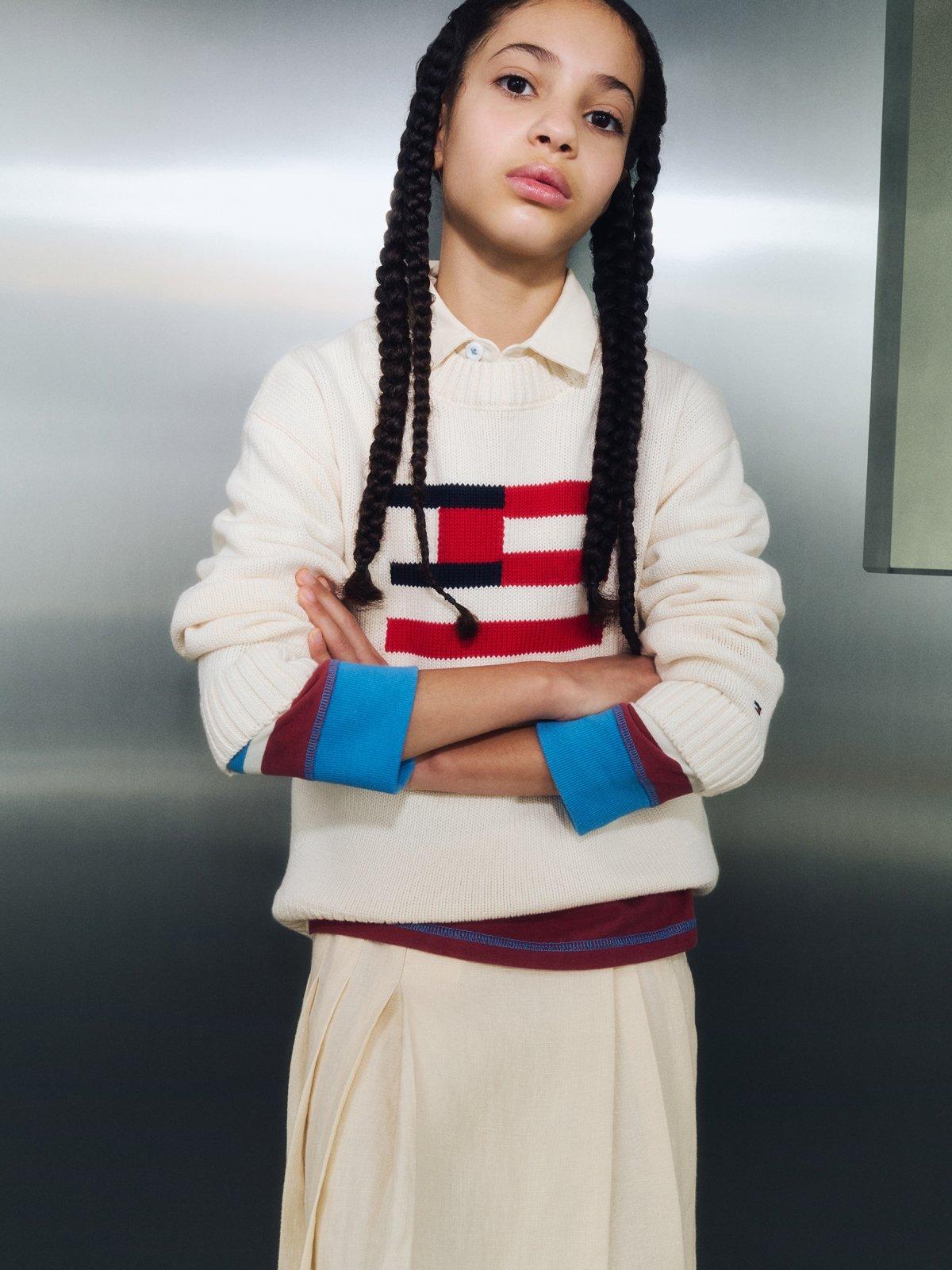 Image of a girl wearing an American flag cream jumper with a cream tulle skirt