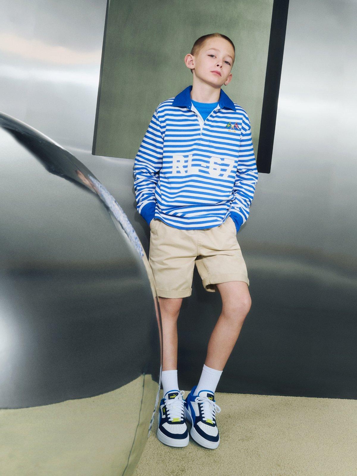 image of a boy standing next to s giant silver balloon