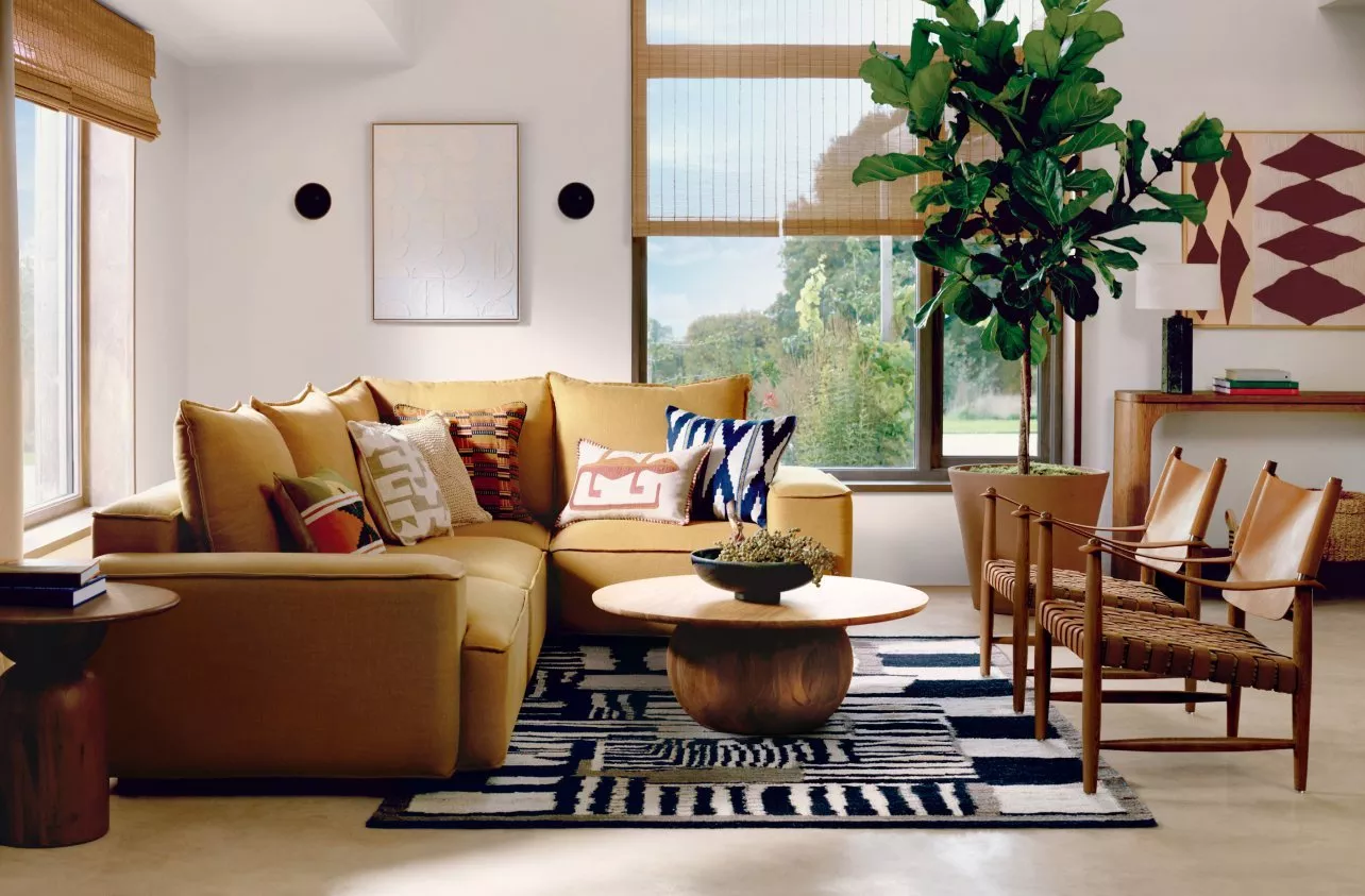 Mid-century modern living room with yellow sofa and rug.