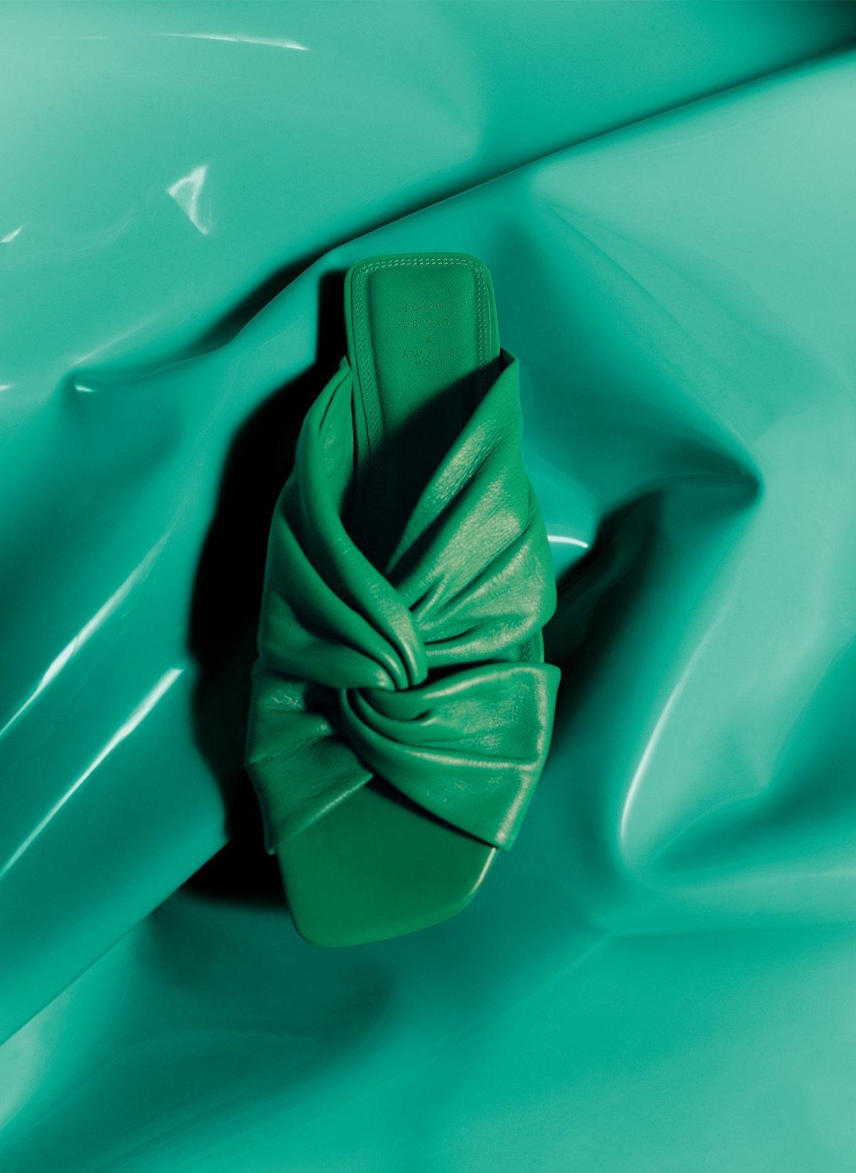a green awake mode shoe on a green pvc background