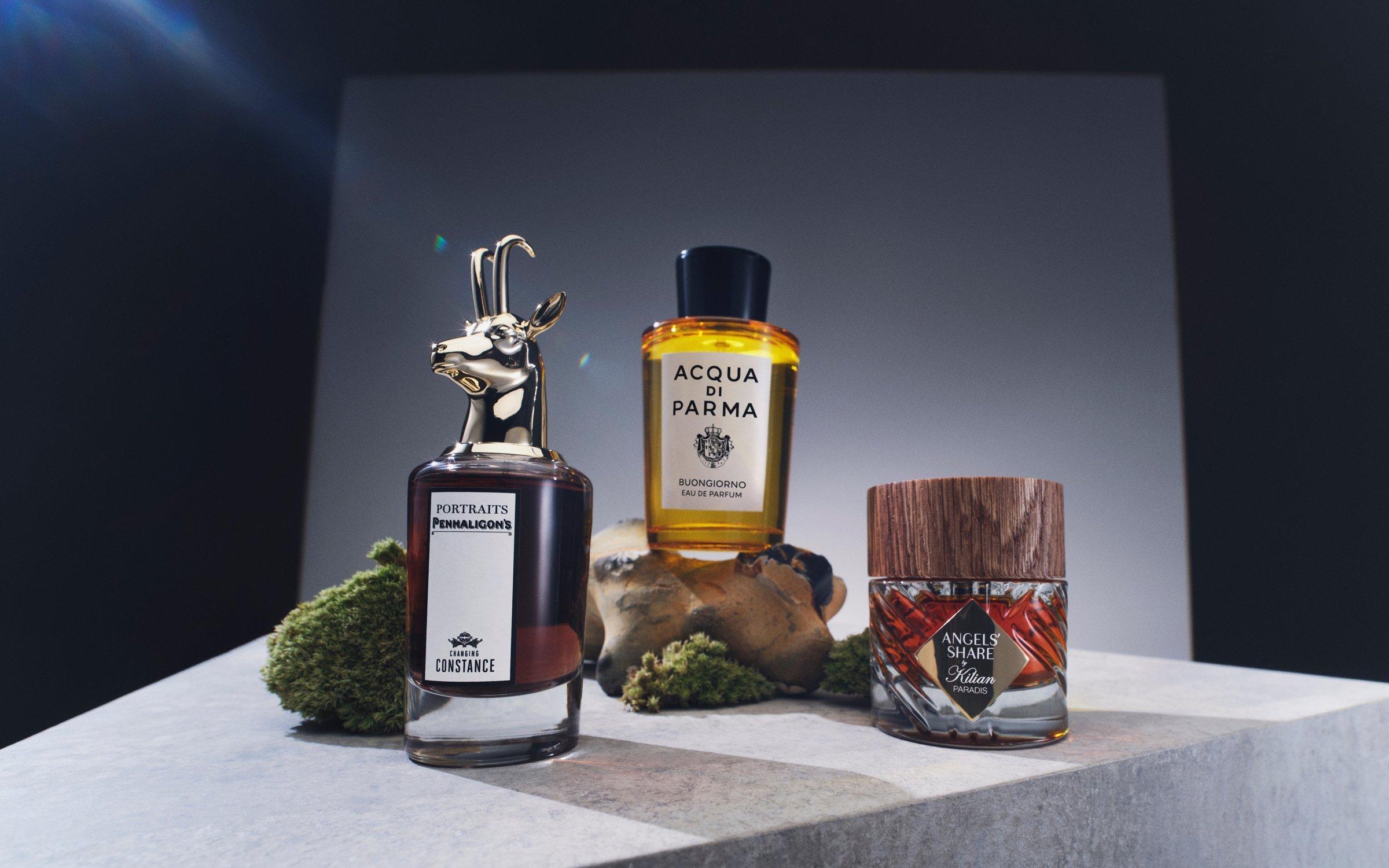 Image of 3 fragrances shot from below, on a silver grey background