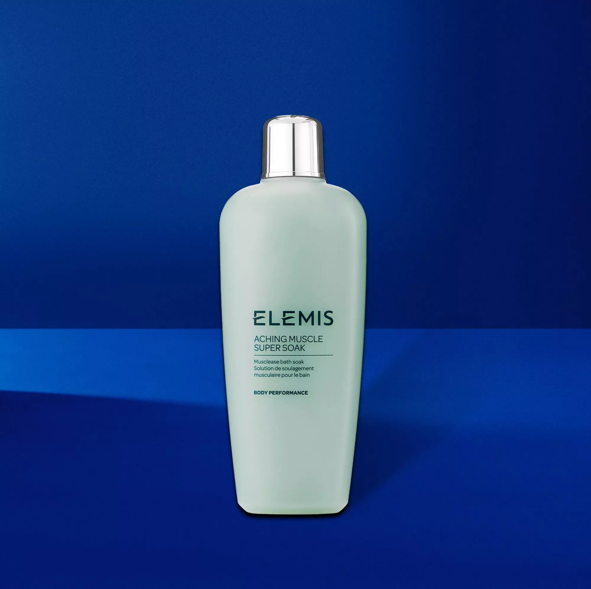 Elemis Aching Muscle Super Soak bath soak bottle on blue background, body performance muscle relief product