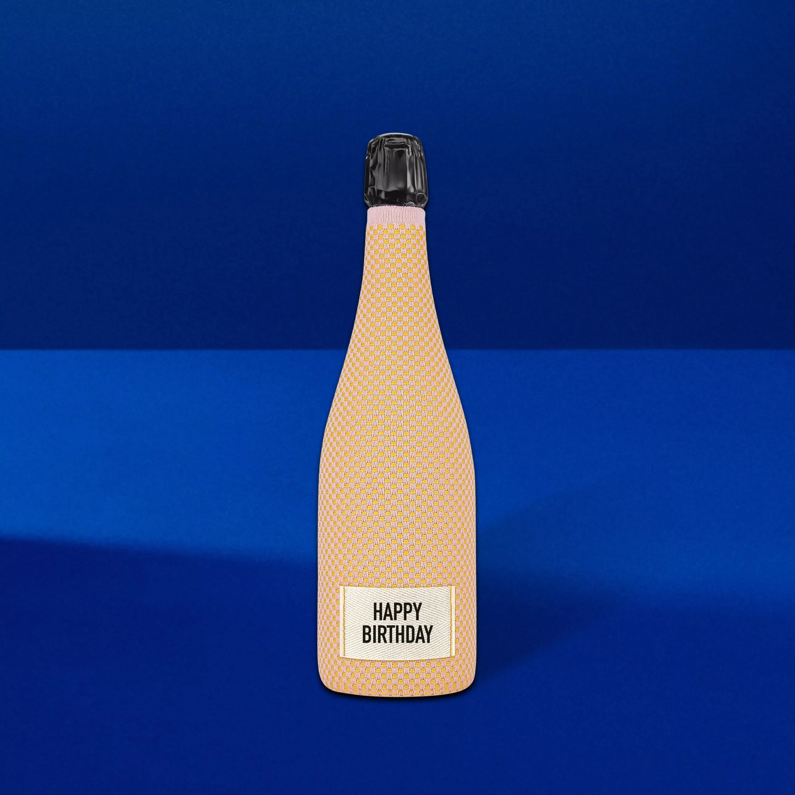 Veuve Clicquot Brute Rose Champagne with Happy Birthday Sleeve on a blue background