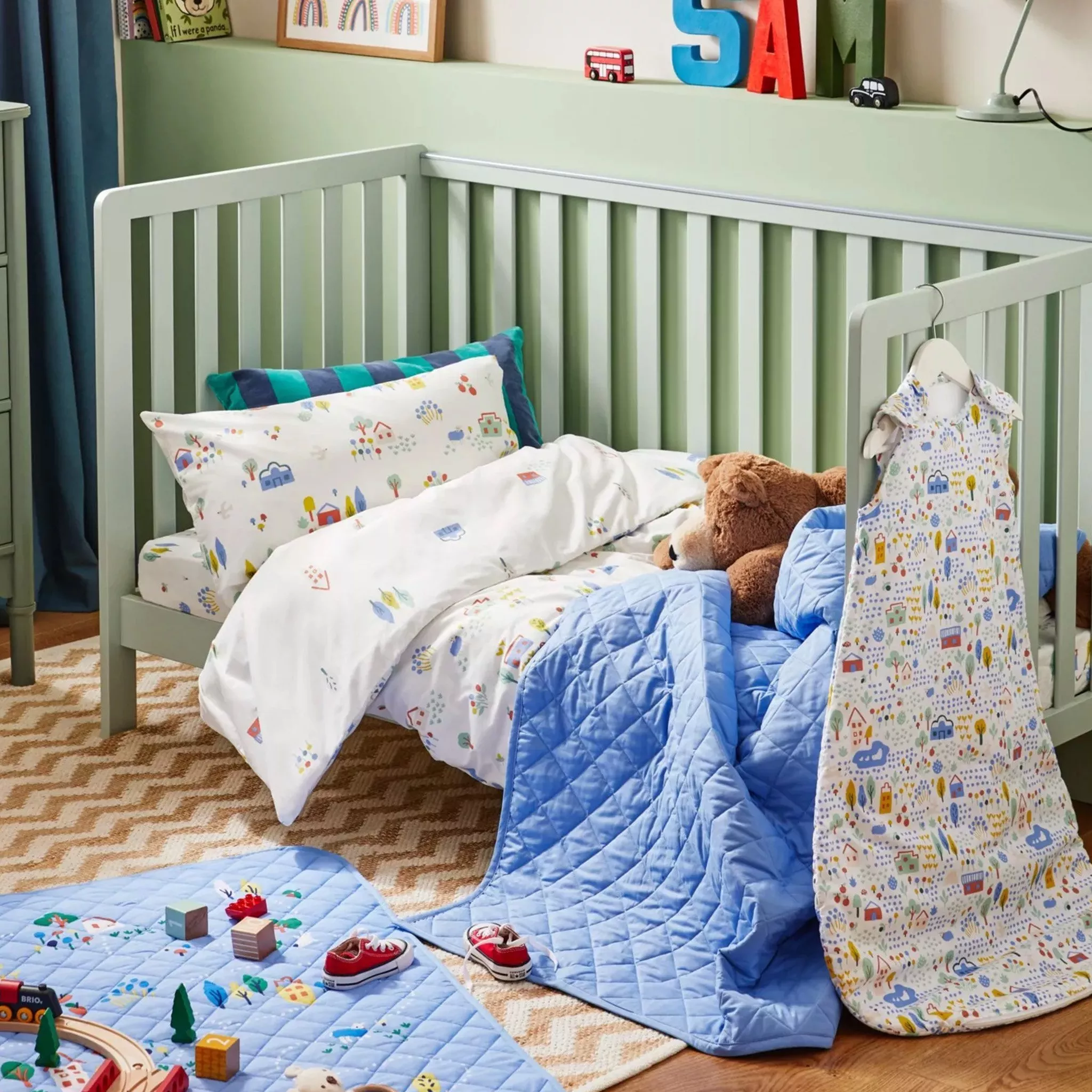 Kids bed with blankets and throw
