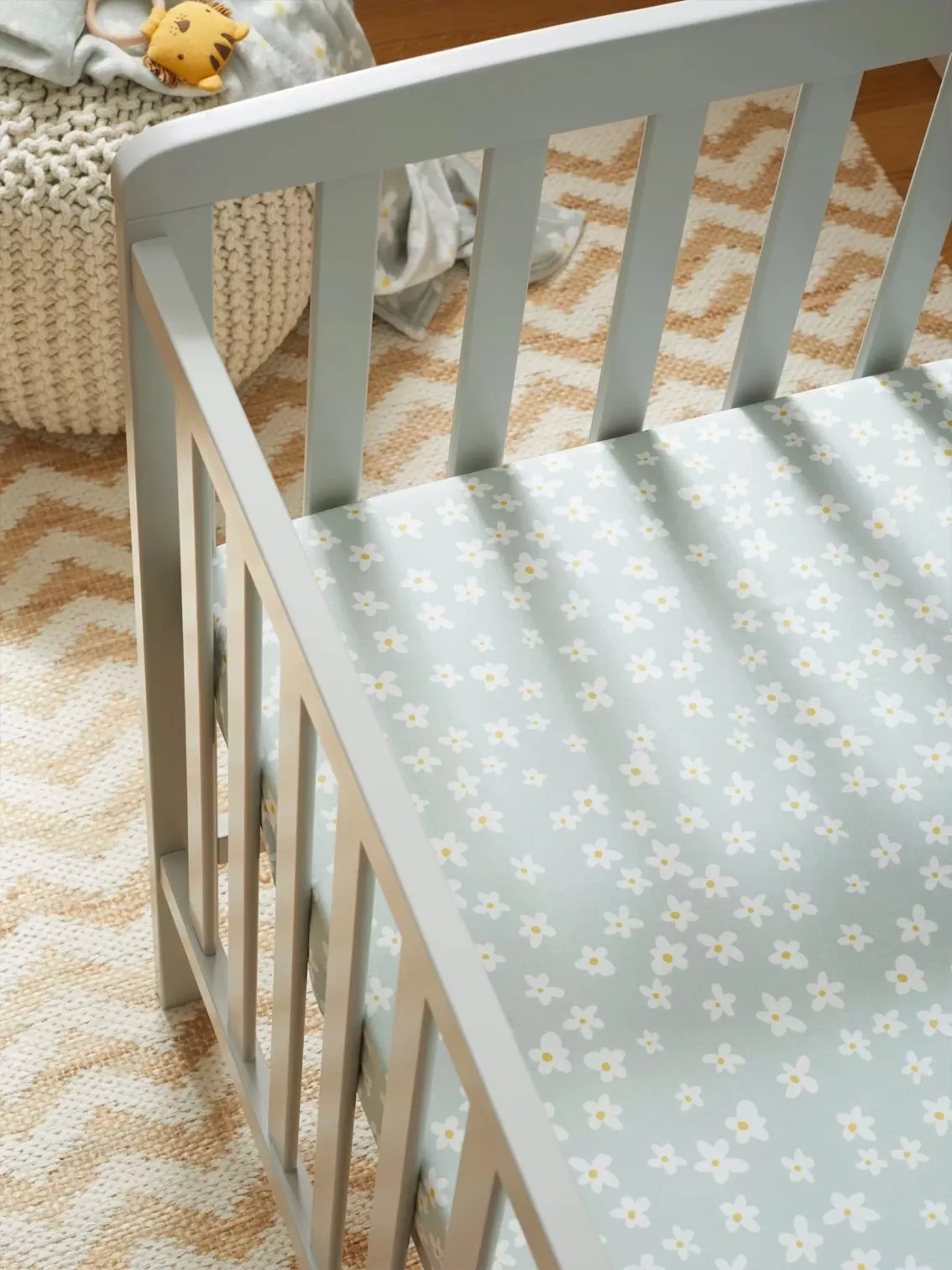 printed fitted sheet in baby's cot