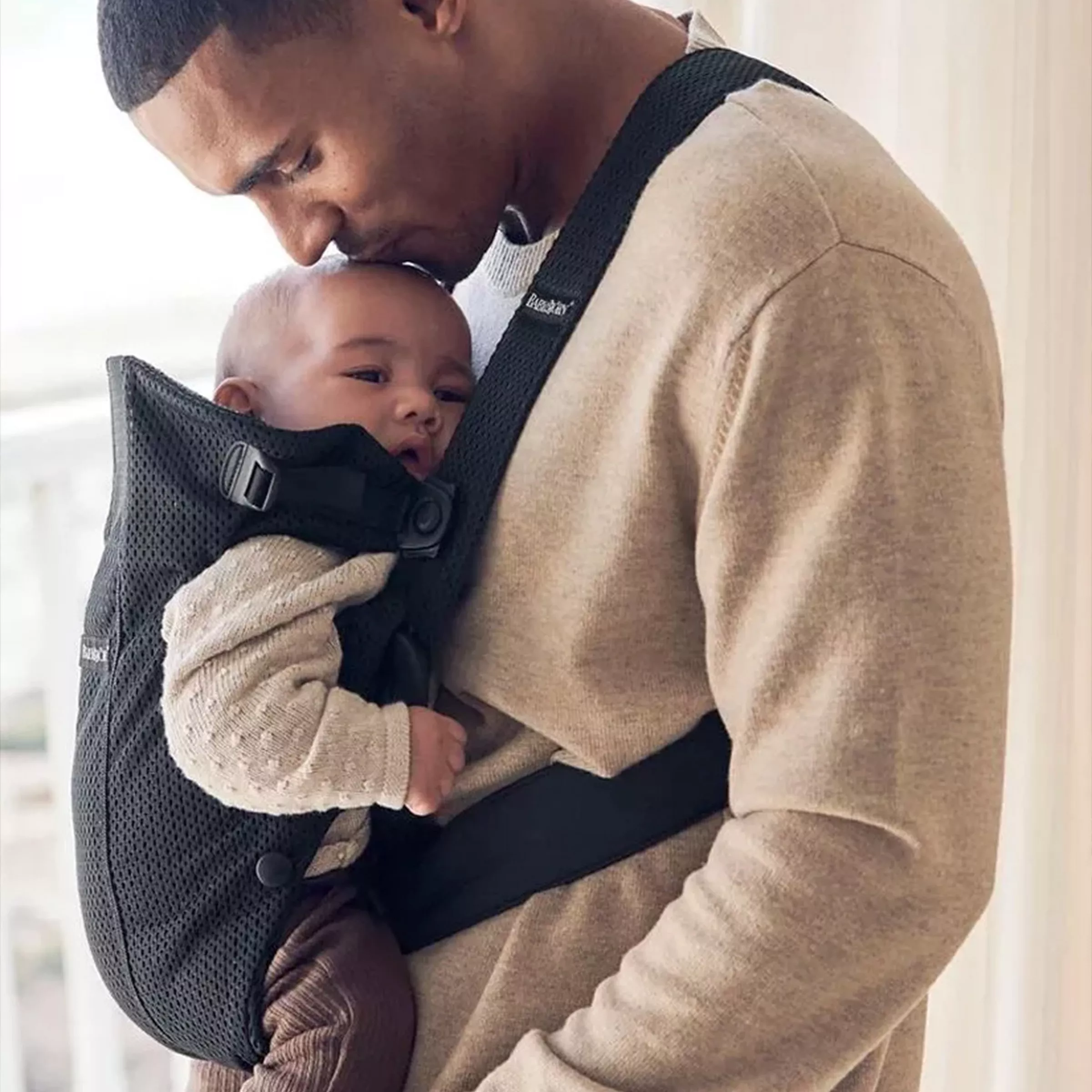 man with baby in carrier