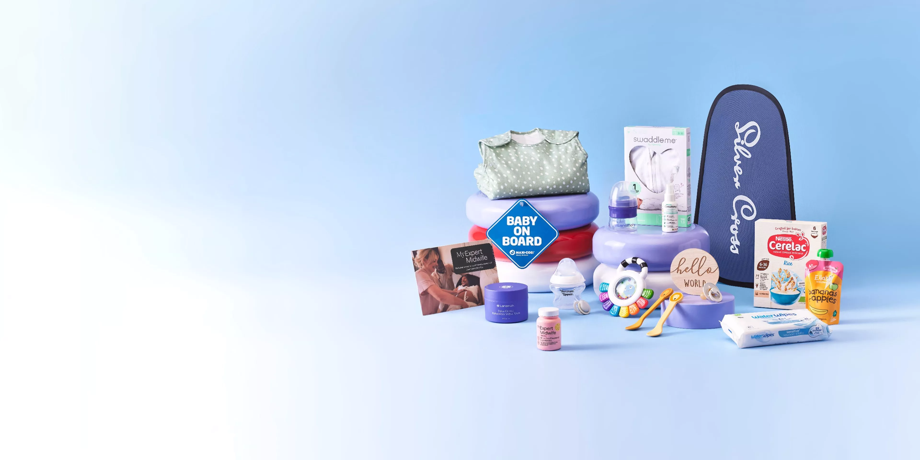 Baby essentials gift hamper with Silver Cross case, swaddle, baby food, wipes, rattle and baby on board sign.