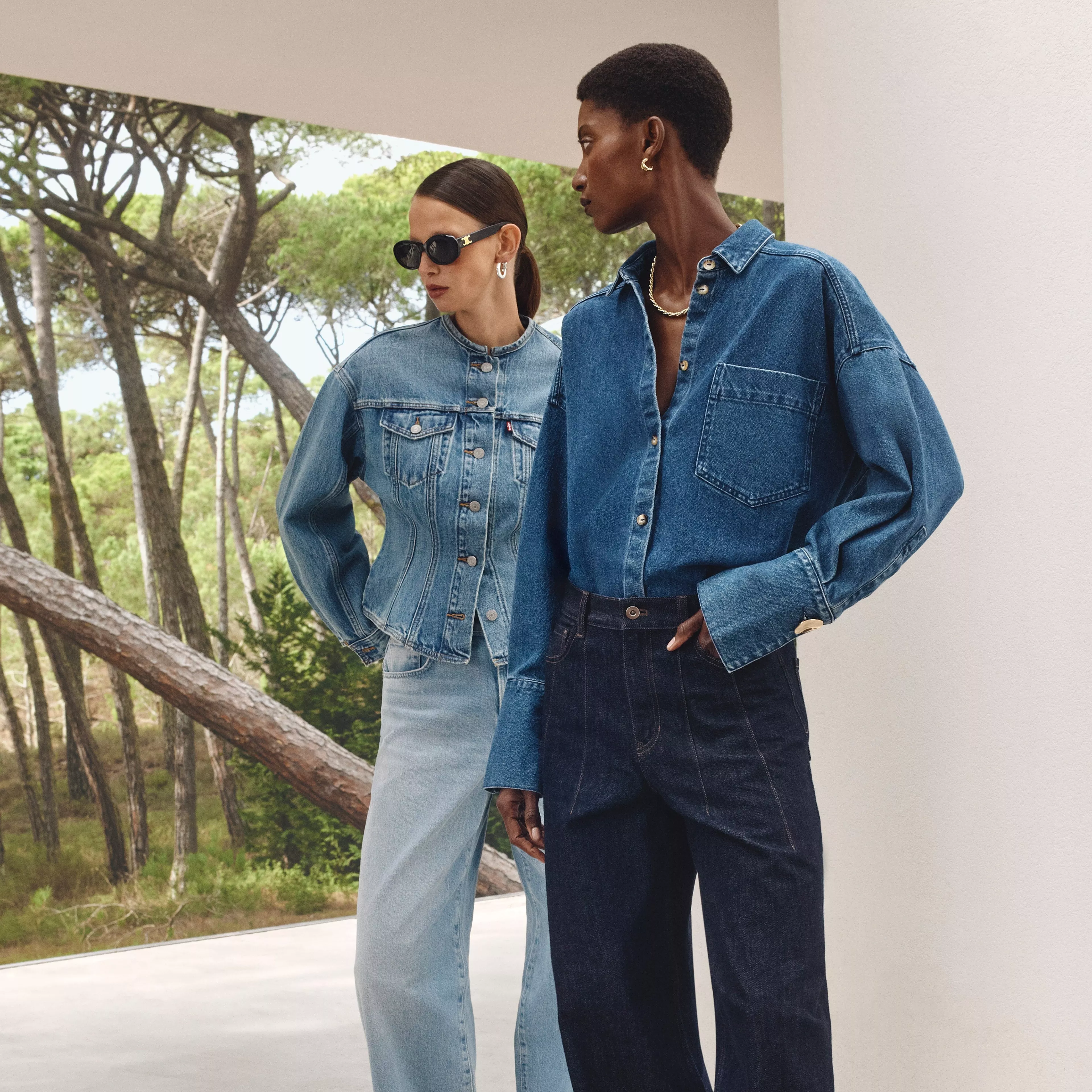 2 ladies wearing denim shirts and jeans