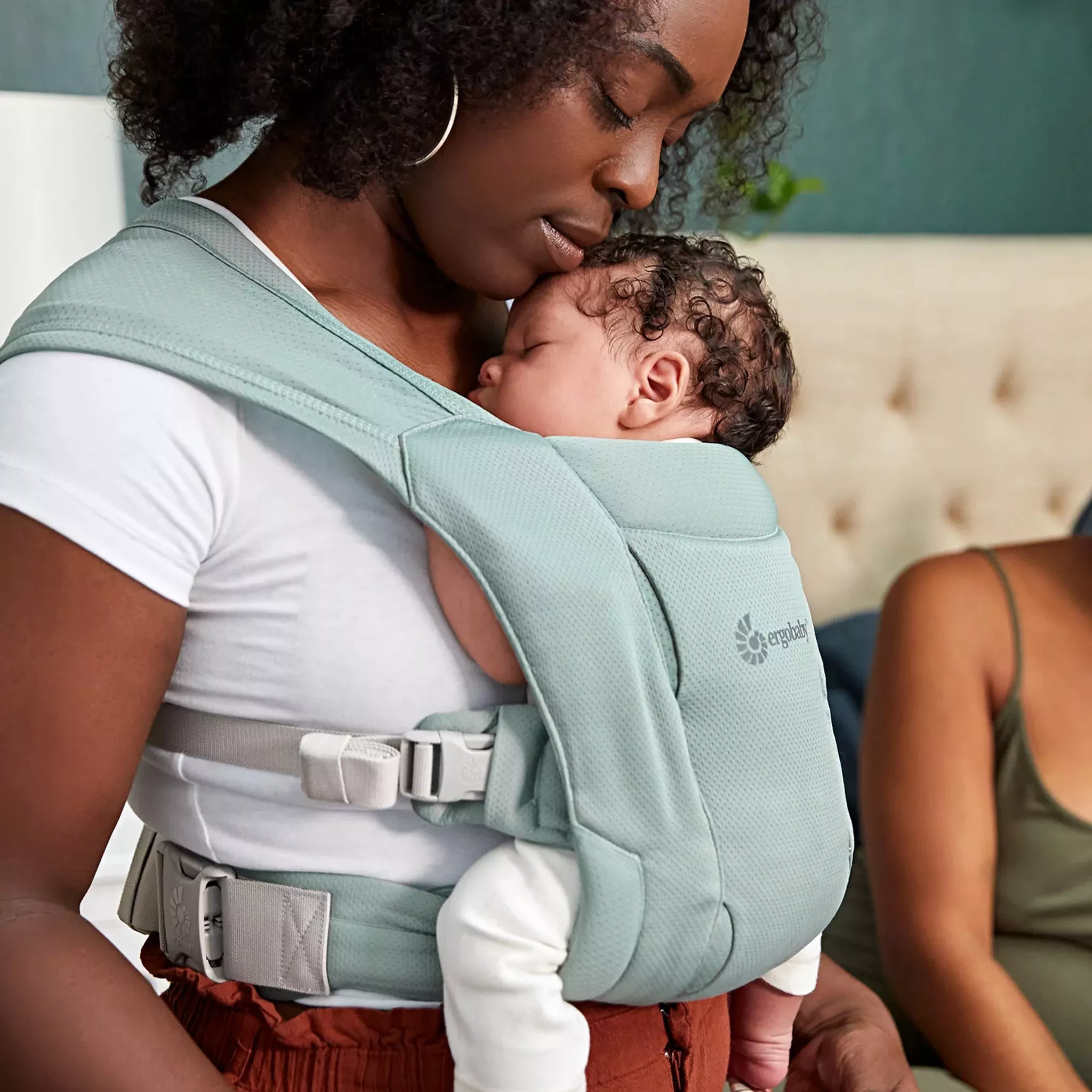 mother with a newborn in a baby carrier