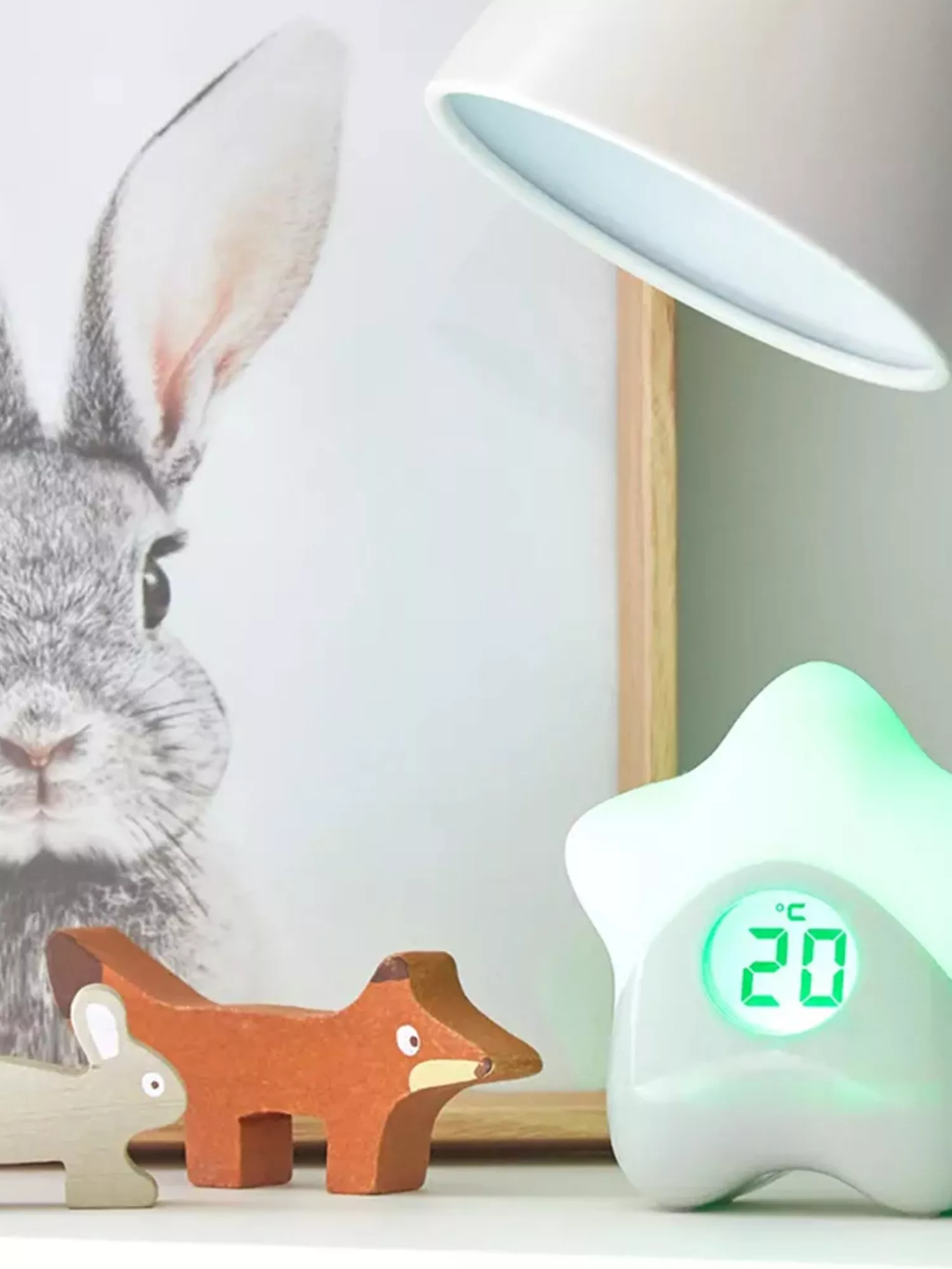 wooden fox and rabbit toys next to a star shaped thermometer glowing green