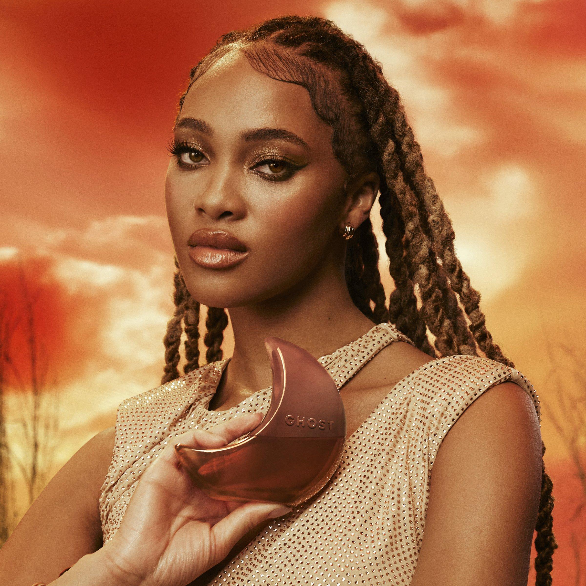 Female model holding a bottle of Ghost Orb of Night Eau de Parfum