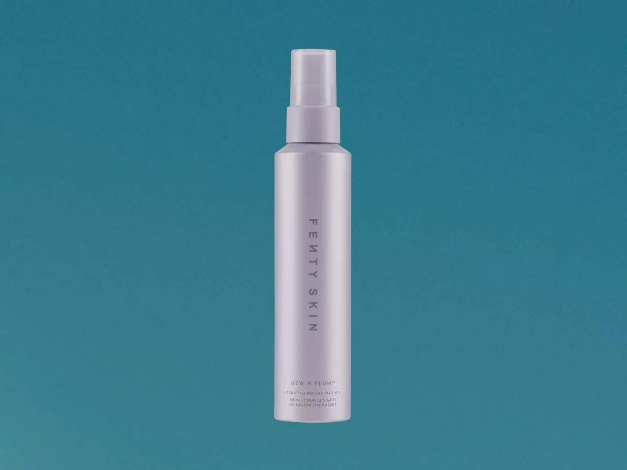 Fenty Skin Dew N Plump hydrating nectar face mist spray bottle on teal background, skincare product photo