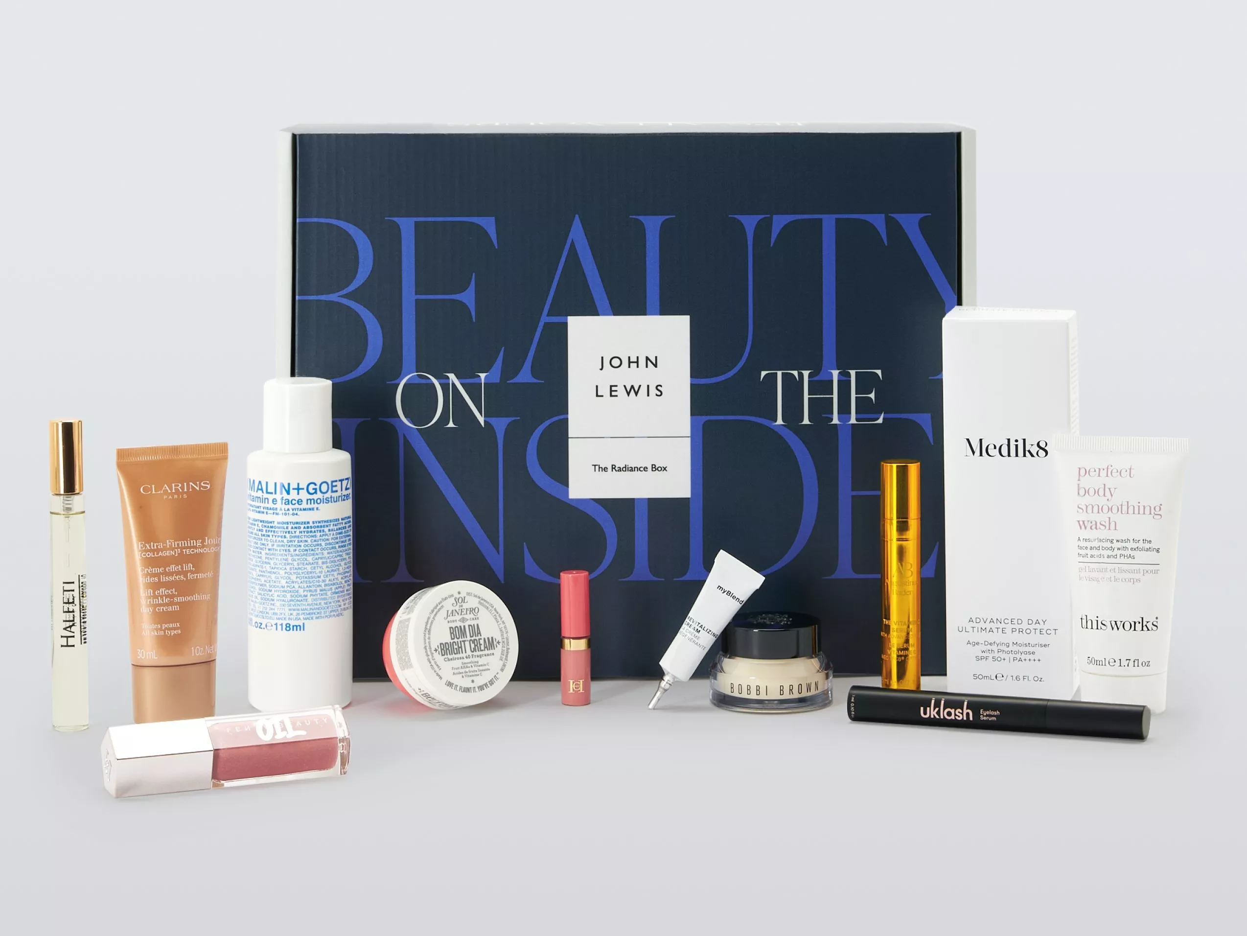 John Lewis The Radiance Box beauty gift set with skincare and make-up minis, displayed in front of branded box