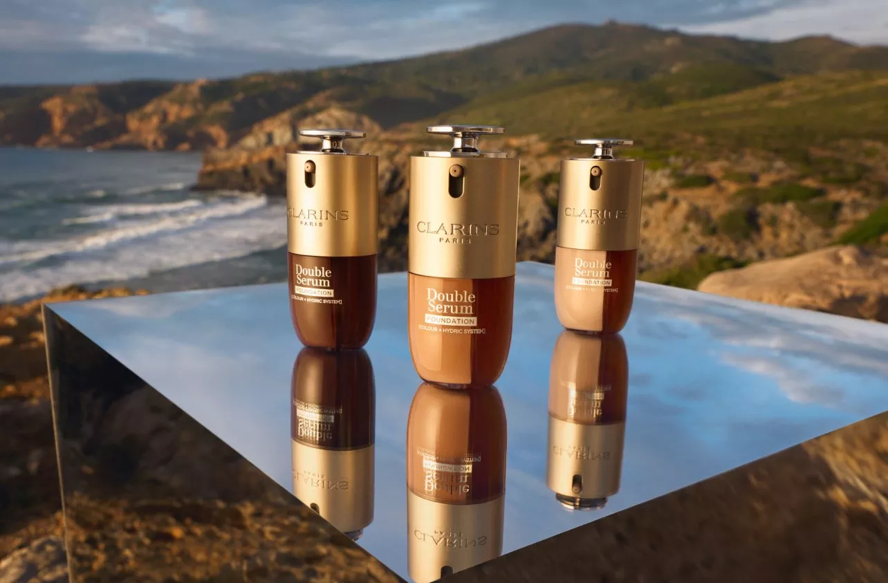 beauty product with a sunny rocky beach scene behind