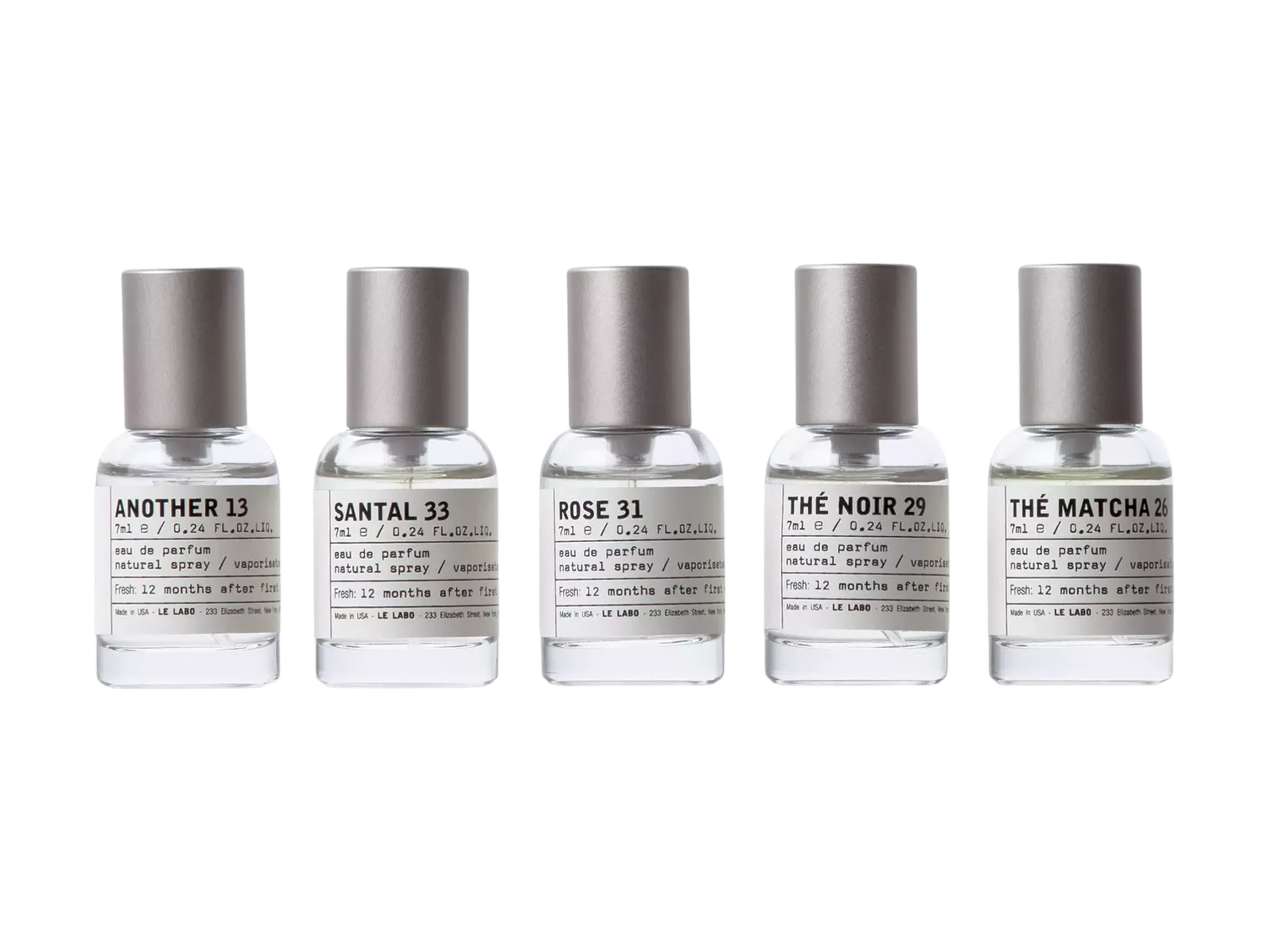 Five Le Labo travel-size eau de parfum bottles lined up: Another 13, Santal 33, Rose 31, Thé Noir 29, Thé Matcha 26