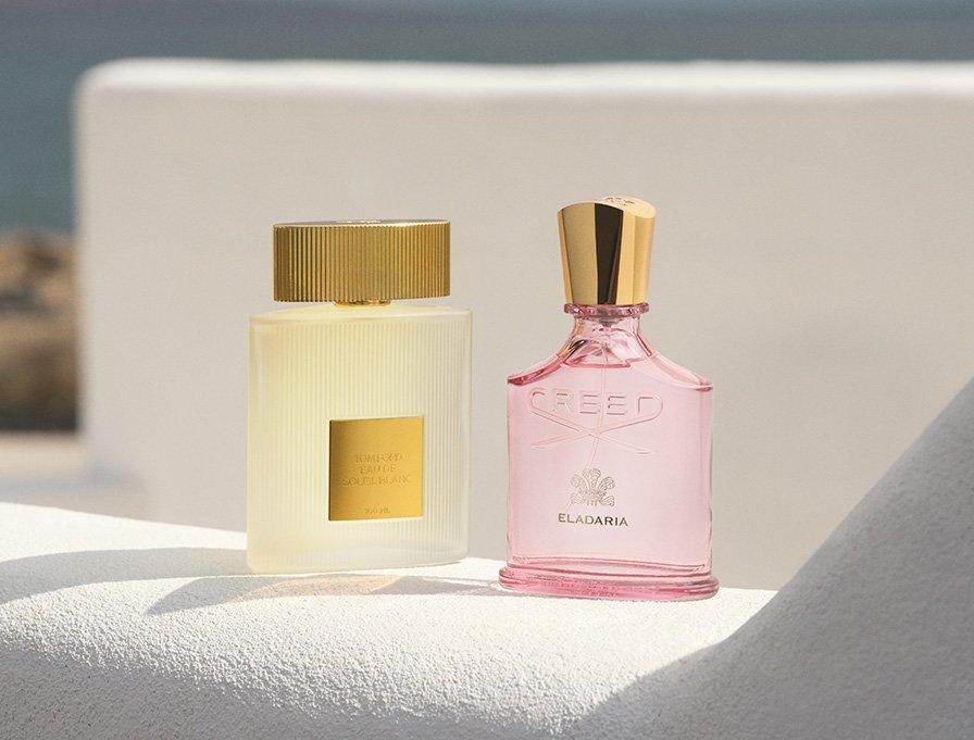 Two Creed fragrances sitting on white ledge