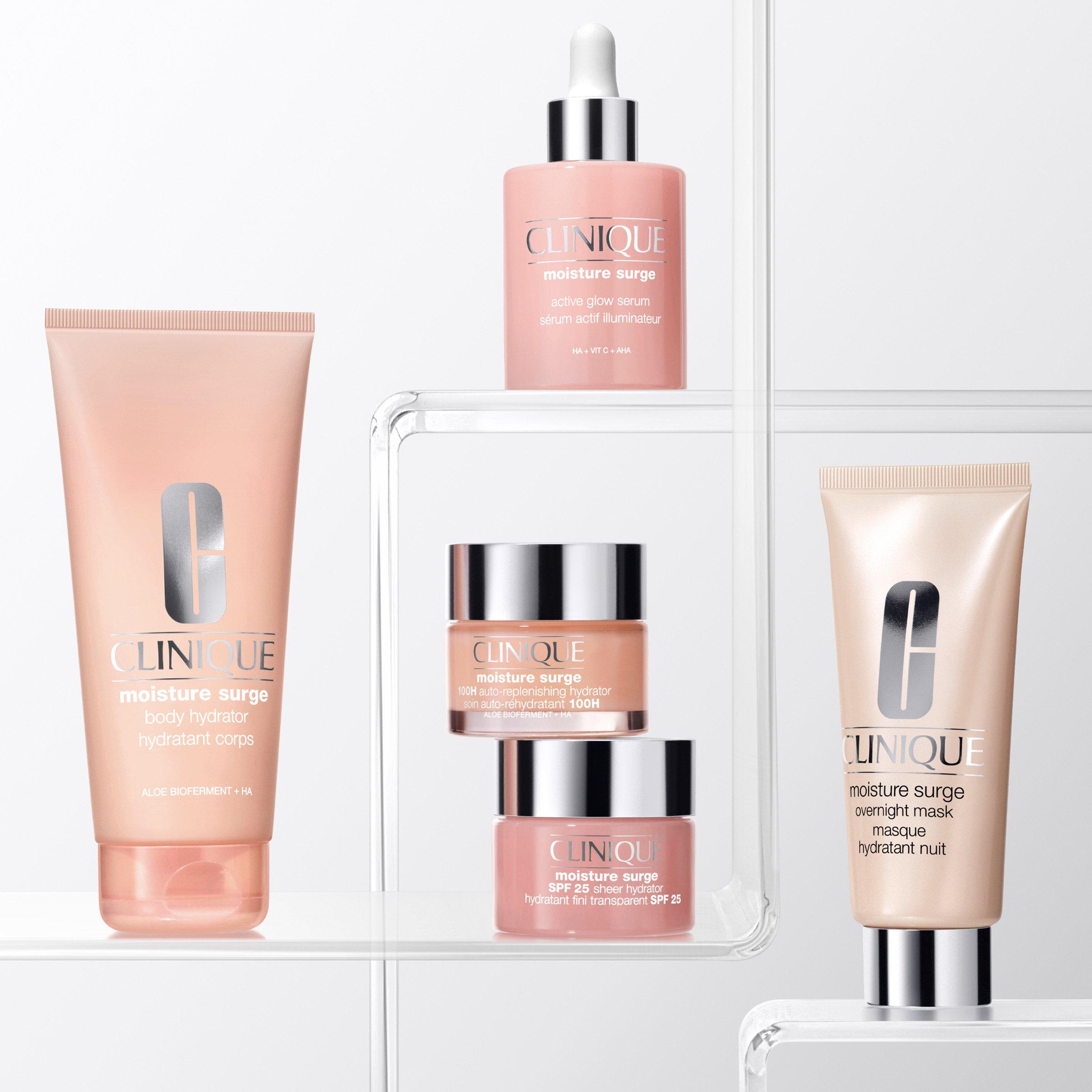 Clinique's Moisture Surge skincare products, soft pink and silver packaging on white clear acrylic shelves