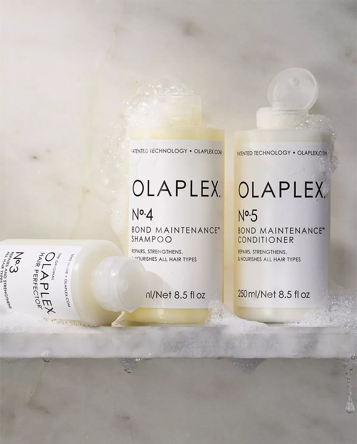 Olaplex shampoo, conditioner and hair perfector on a shelf