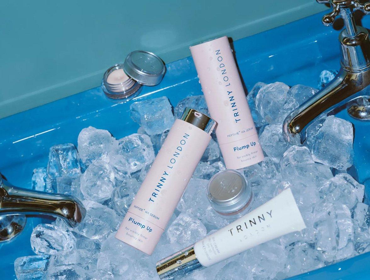 Trinny London products in a blue sink filled with ice