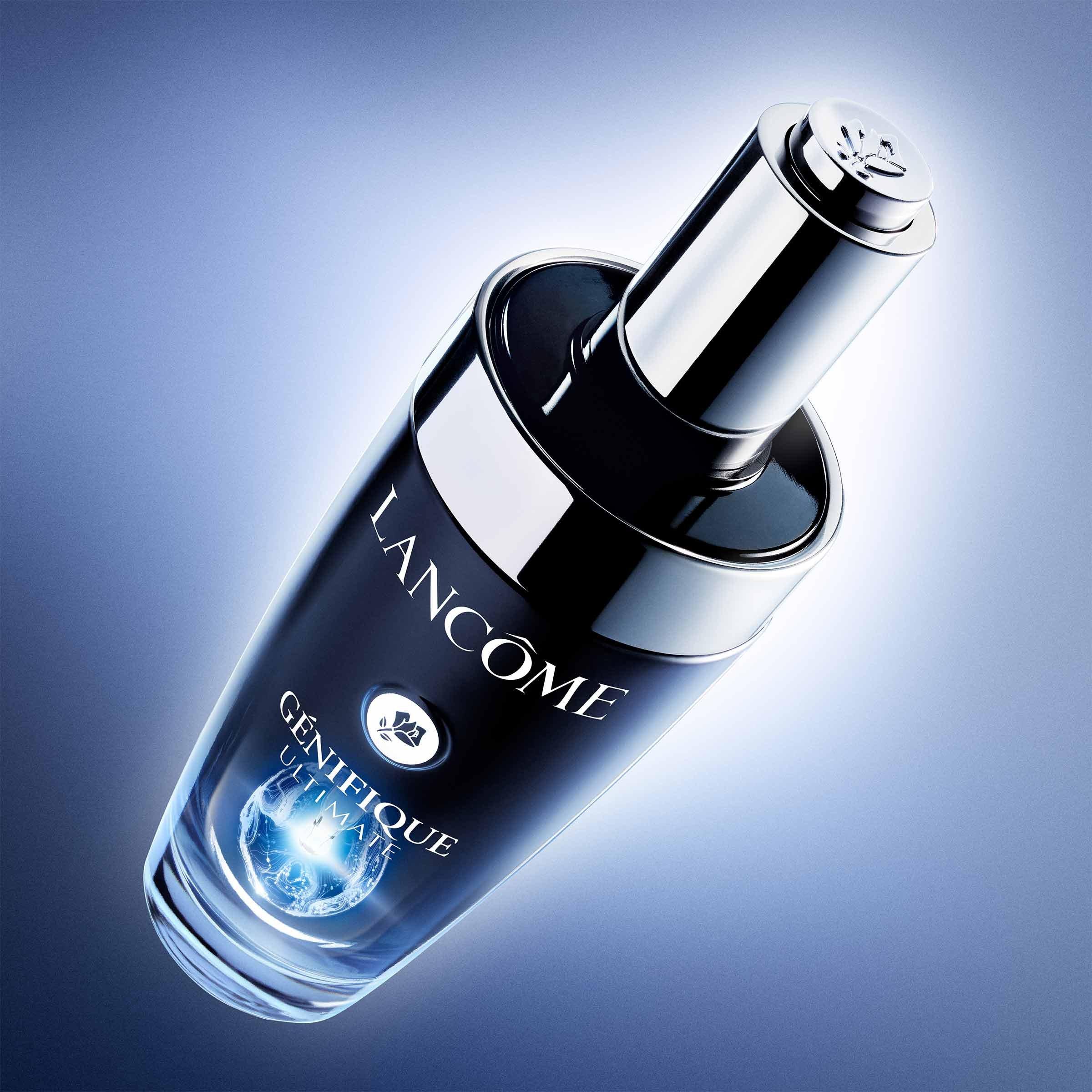 Product shot of Lancôme Génifique Ultimate Serum glowing on a blue background