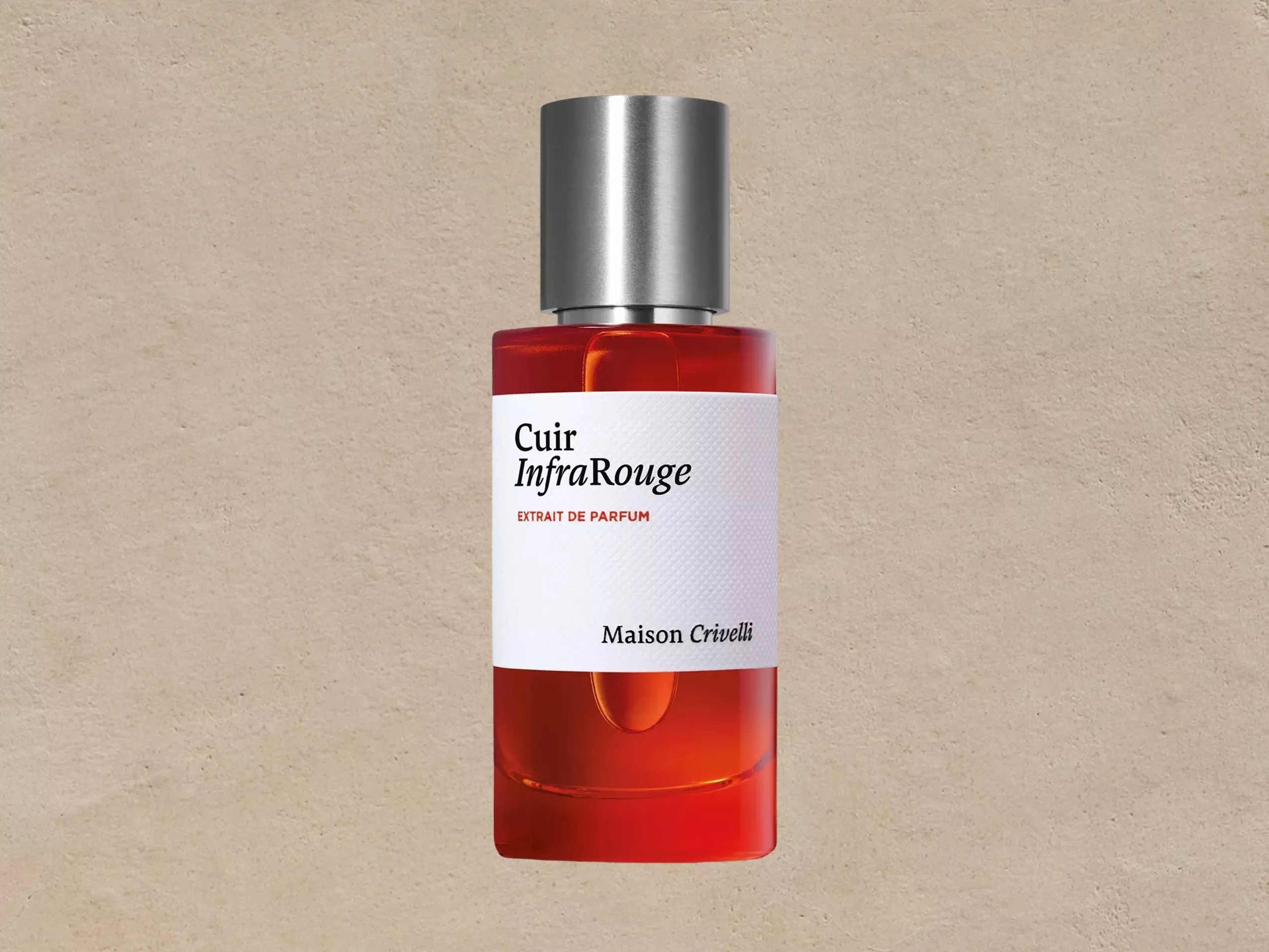 Maison Crivelli Cuir InfraRouge extrait de parfum bottle, red glass fragrance with silver cap on beige background