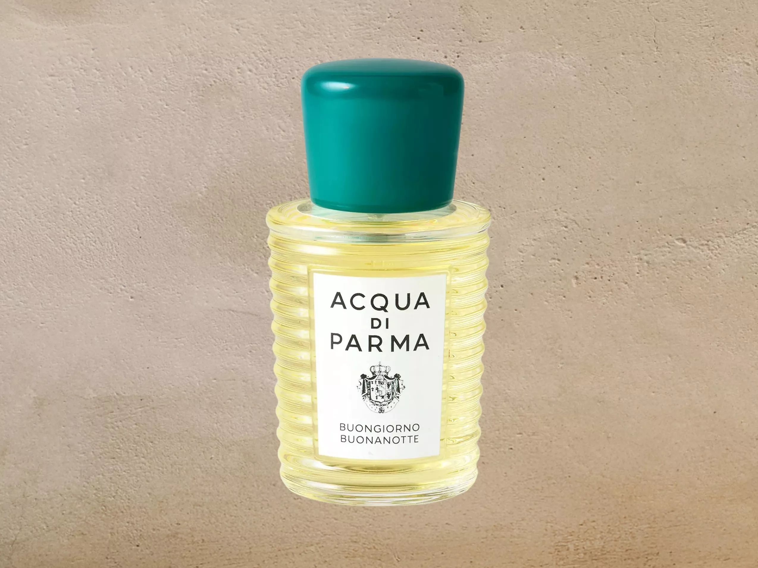 Acqua di Parma Buongiorno Buonanotte fragrance bottle with teal cap on a neutral stone background