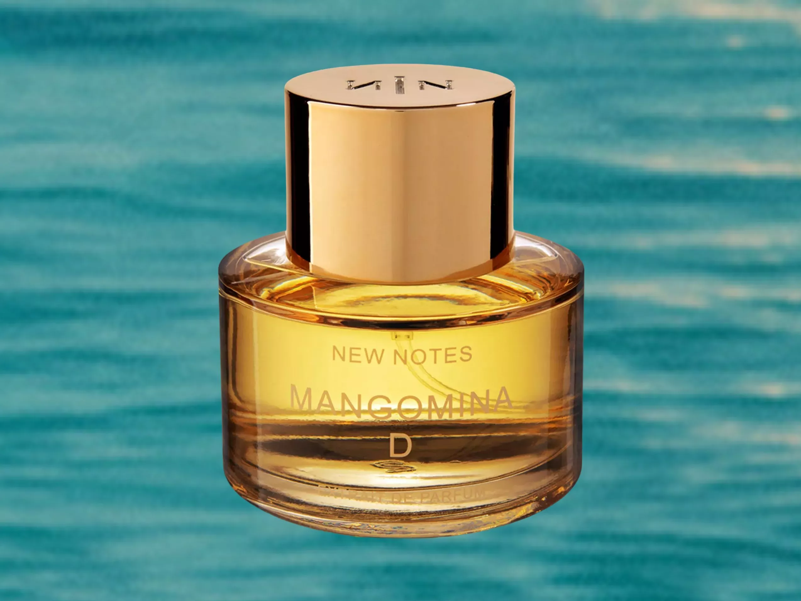 New Notes Mangomina D perfume bottle with gold cap, luxury fragrance product on blue water background