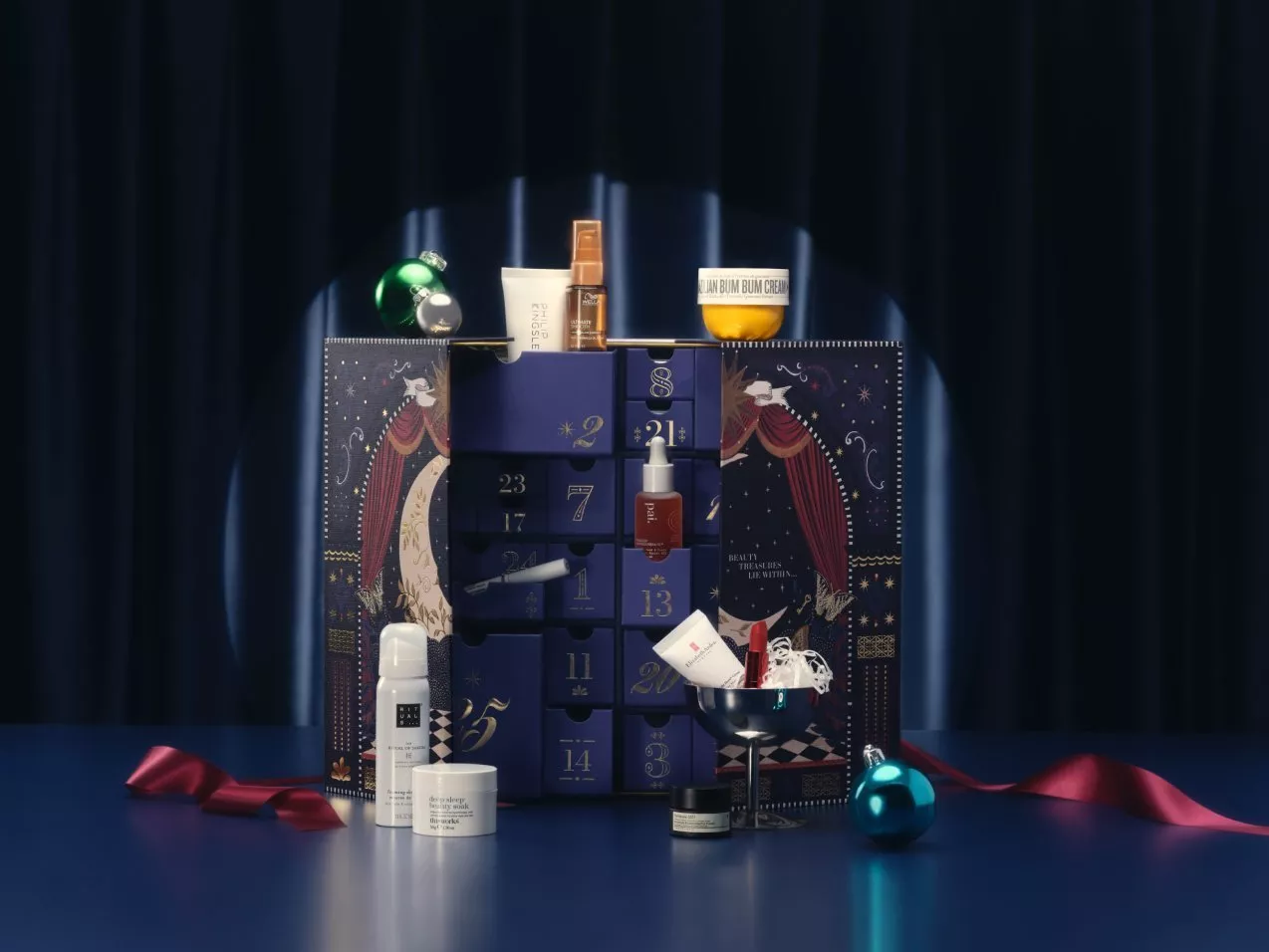 a beauty calendar on a blue velvet backdrop