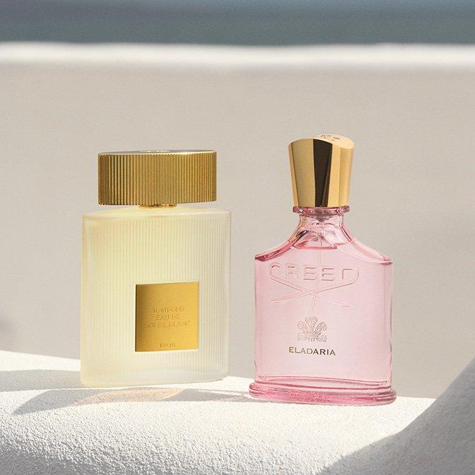 Tom Ford and Creed frangrances sitting on white ledge