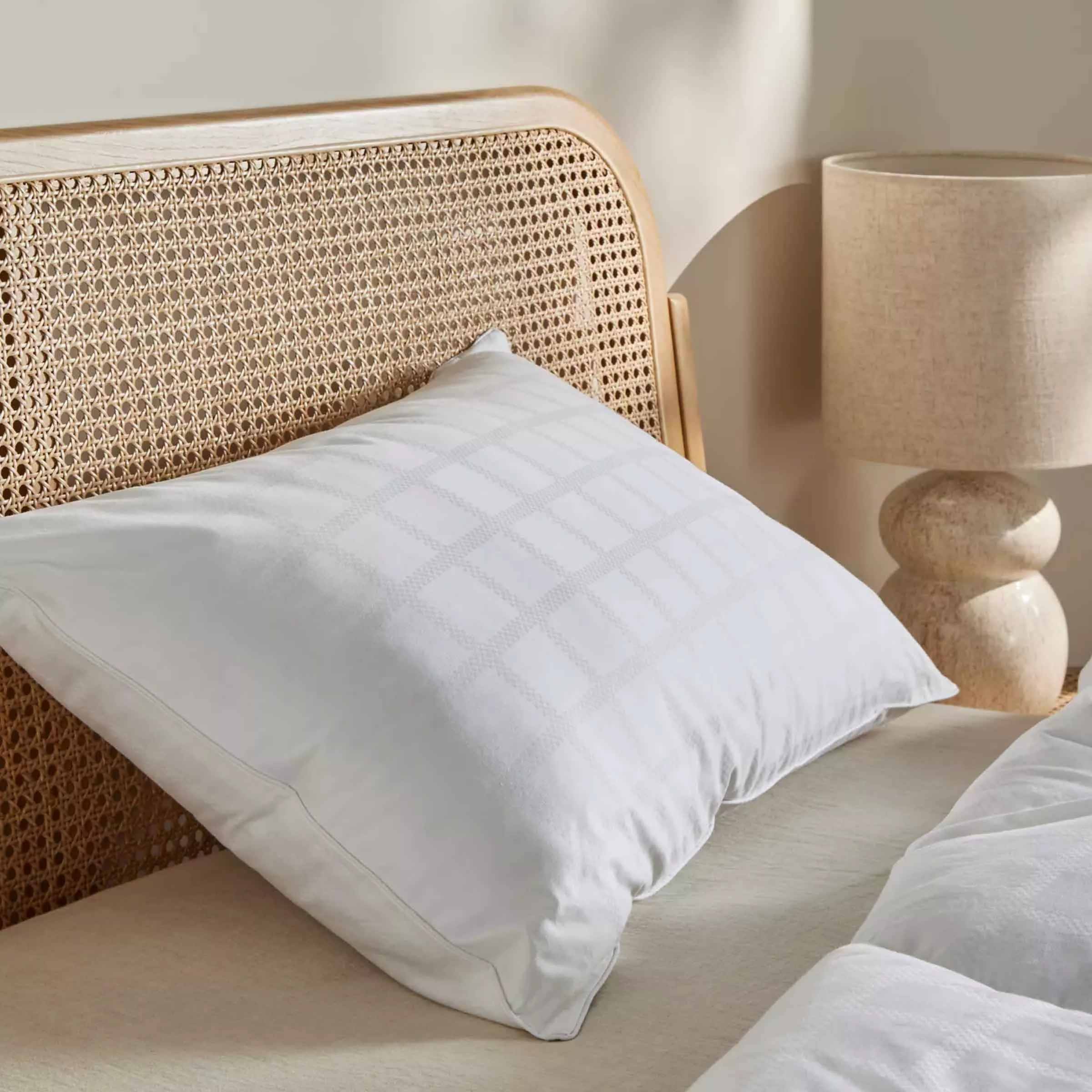 White pillow on a rattan wooden bed