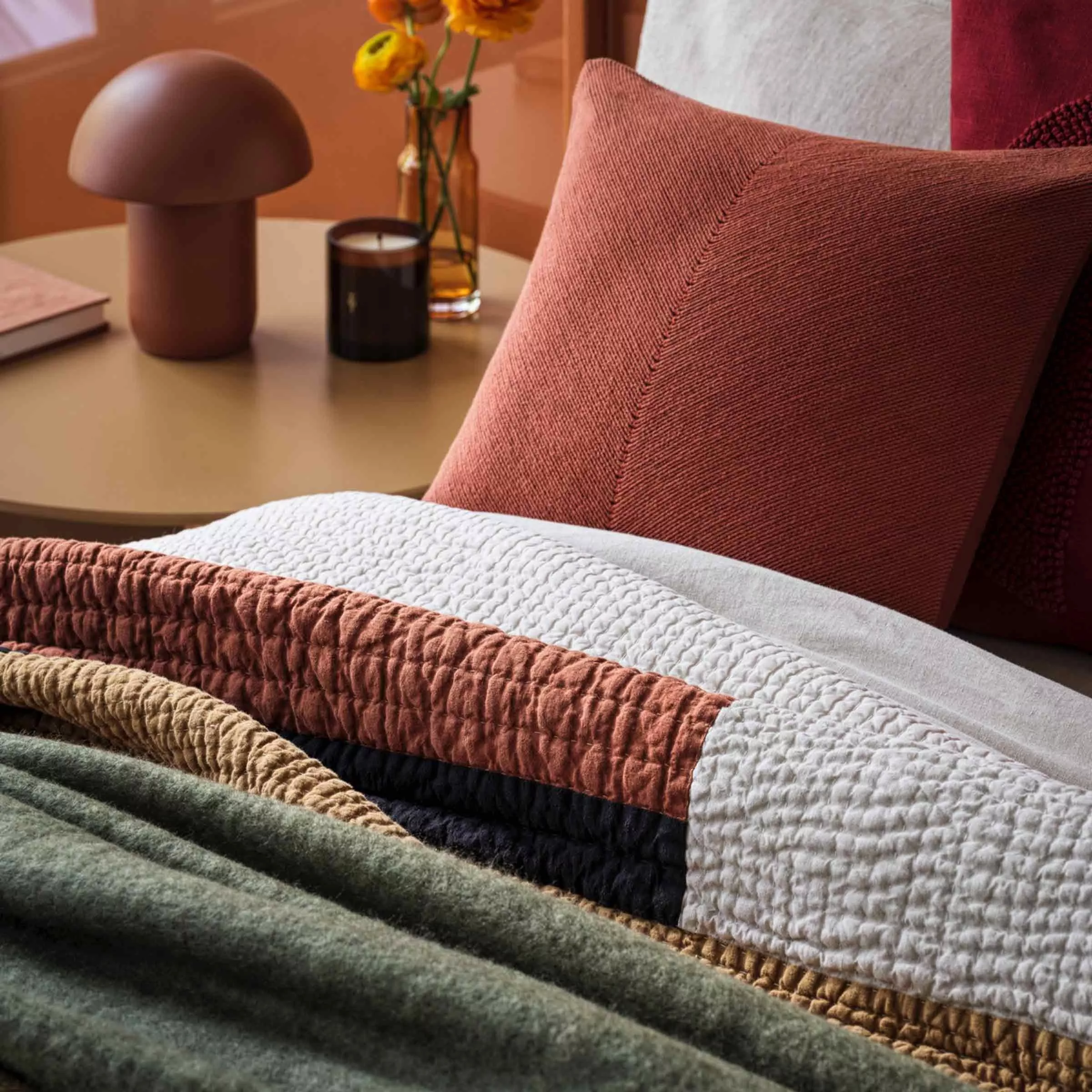 Bed with red, green, yellow and white bedding