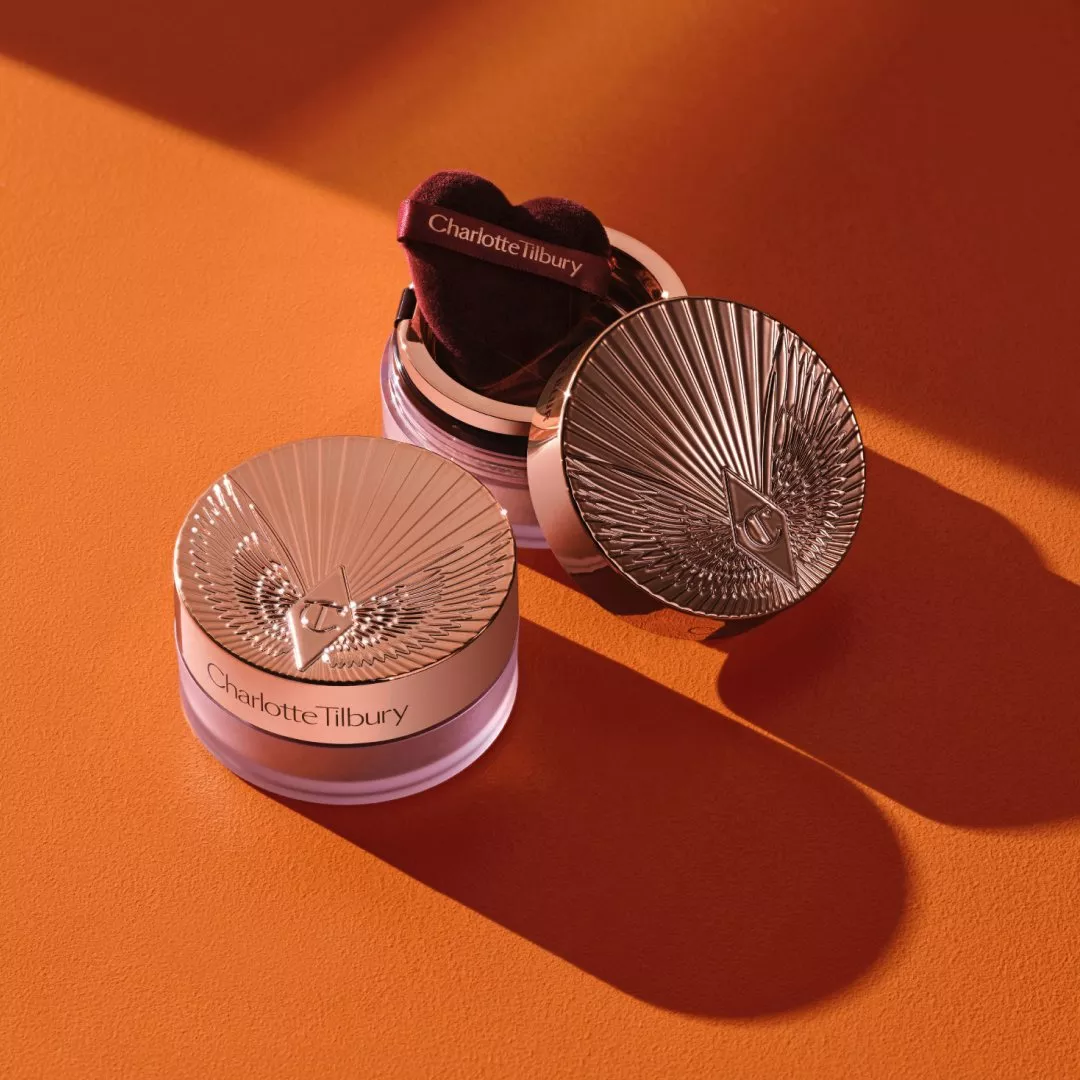 Charlotte Tilbury Airbrush Flawless Loose Setting Powder open compact with puff on pink powder backdrop