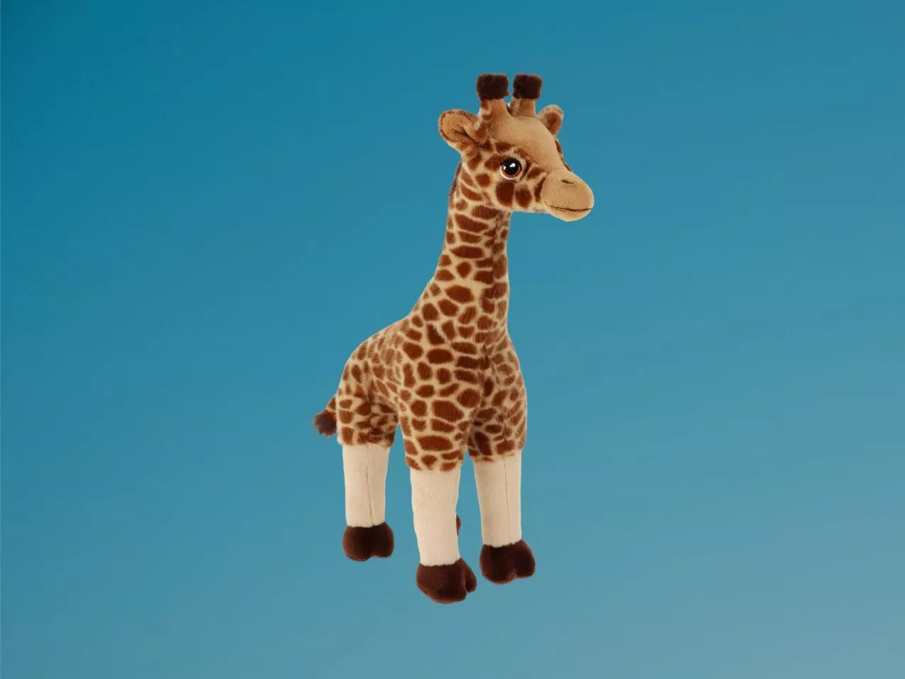 Soft plush giraffe toy with brown spots, long neck and cute face, against white background