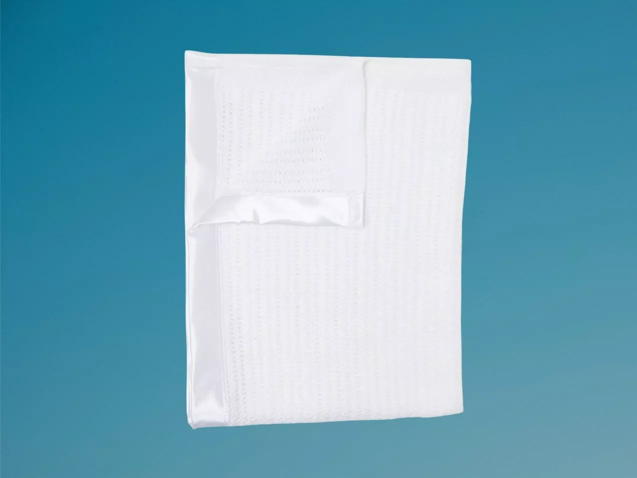 White organic cotton baby blanket with a soft satin trim