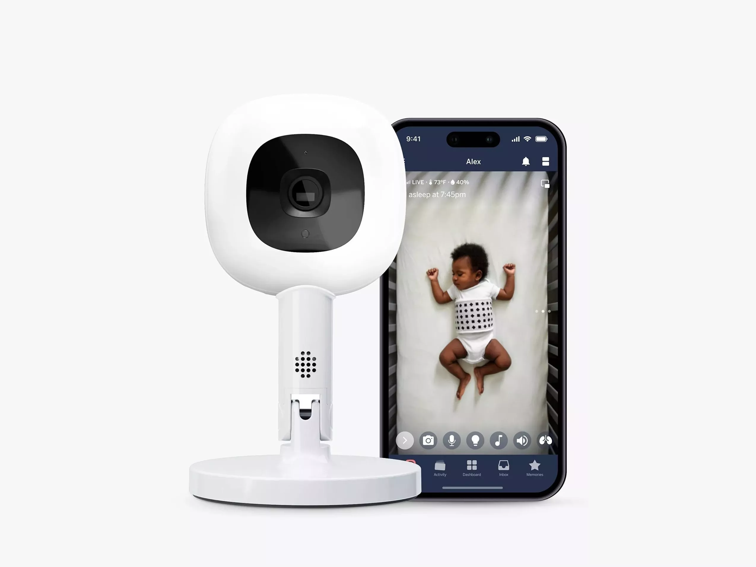 Smart baby monitor camera on stand beside smartphone showing live video of sleeping baby in cot