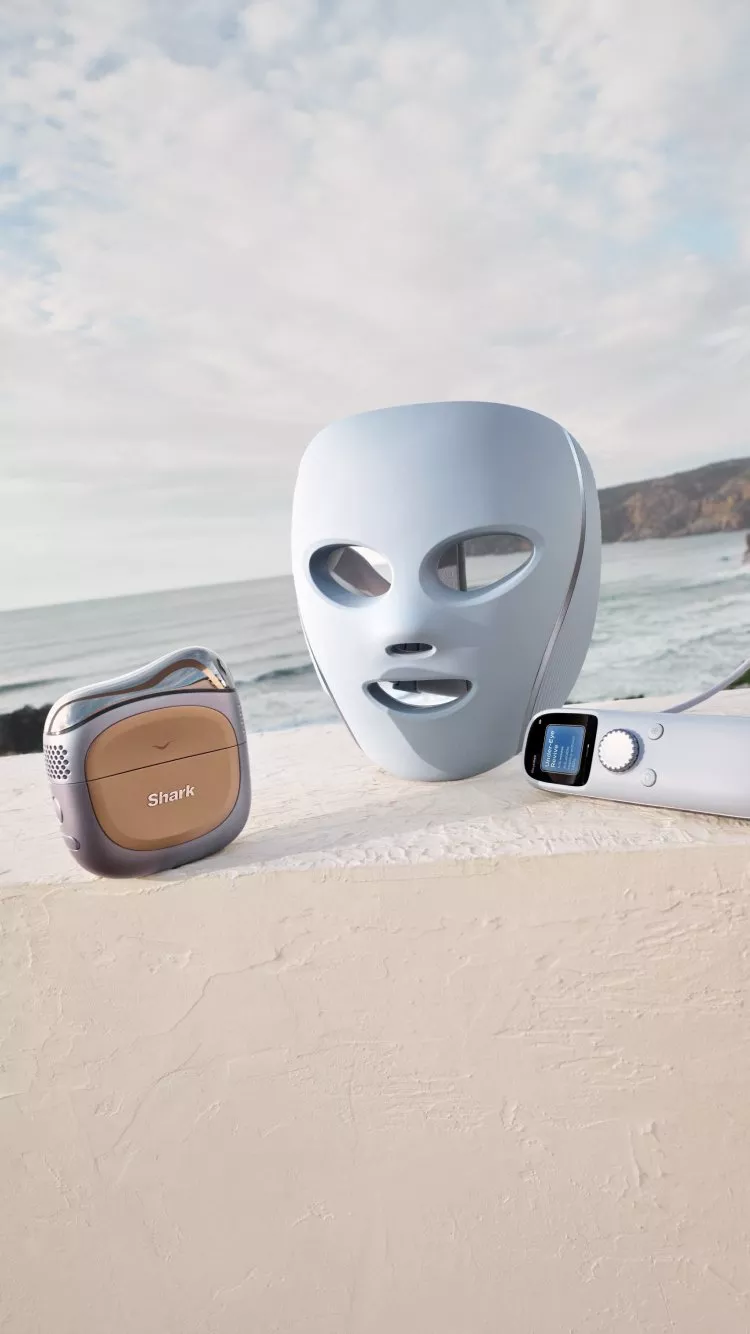 Stylish Shark hair tools on a ledge with a scenic ocean view, featuring sleek design and modern technology.