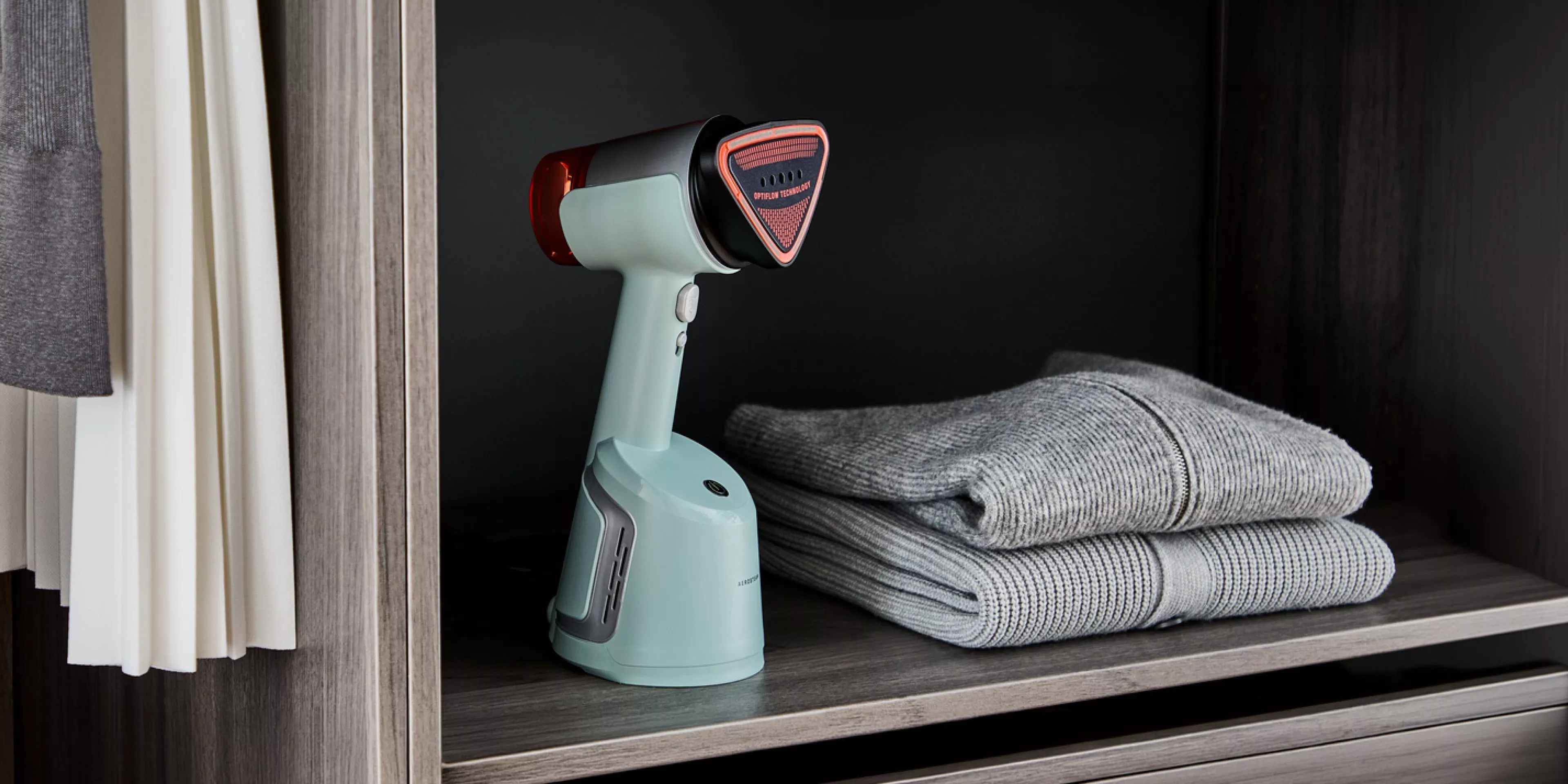 An Aerosteam DT9814 clothing steamer sitting on a closet shelf