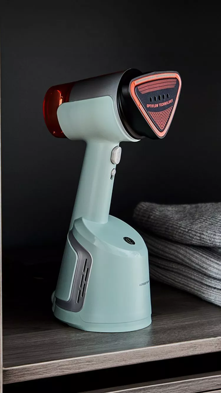 An Aerosteam DT9814 clothing steamer sitting on a closet shelf