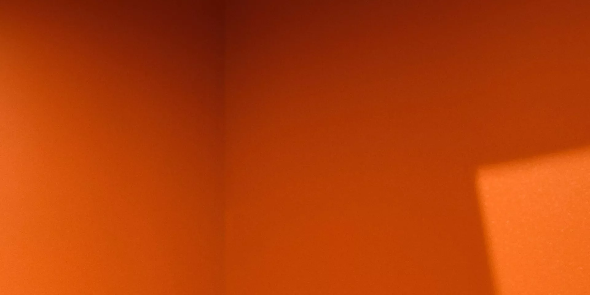 Abstract orange gradient background with soft light and shadow, warm texture ideal for modern web design banner
