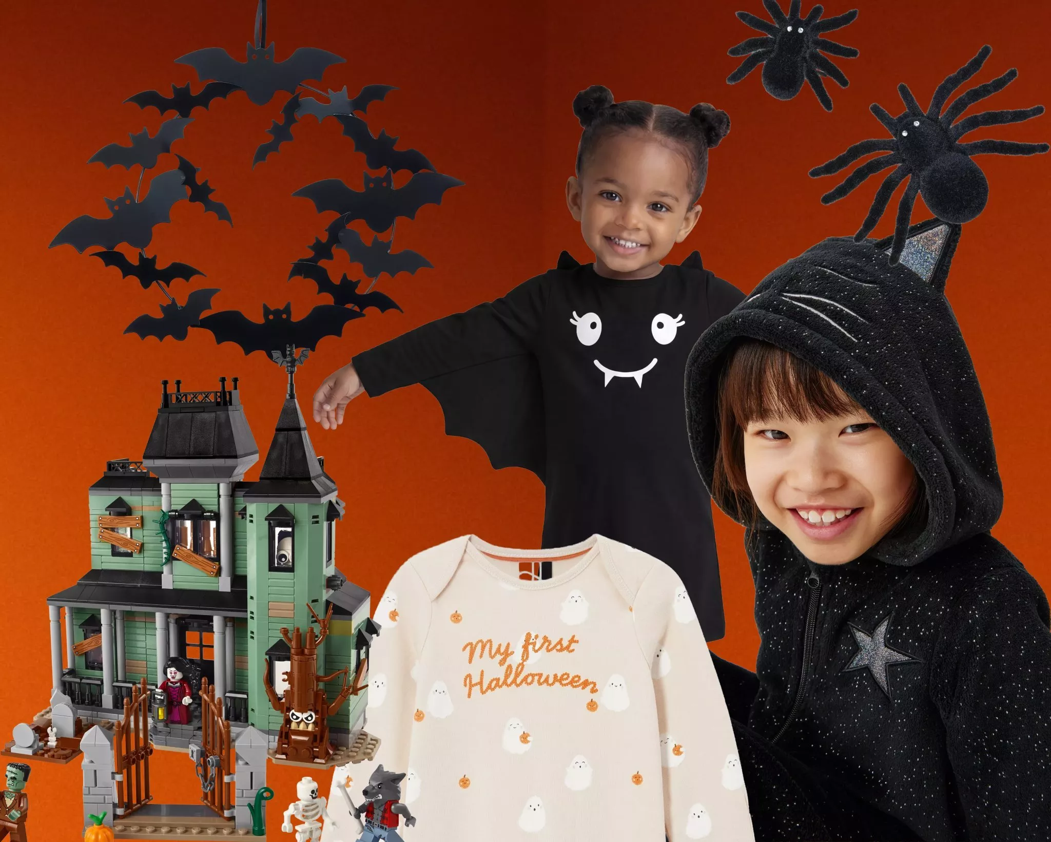  A little girl wearing a black cat Halloween onesie with a LEGO haunted house in the background