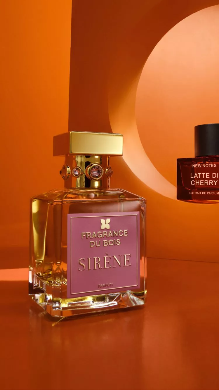 Fragrance Du Bois Sirène parfum bottle on orange studio set, luxury perfume photography with warm shadows