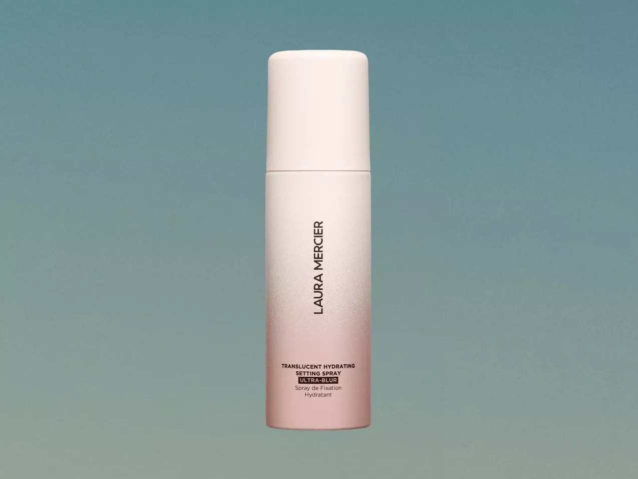 Laura Mercier translucent hydrating setting spray Ultra Blur bottle on teal background