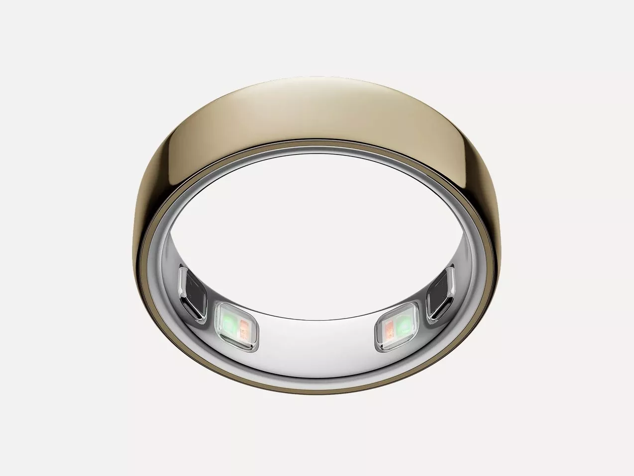 Gold smart ring with built-in health sensors and LED lights, shown in close-up on a white background