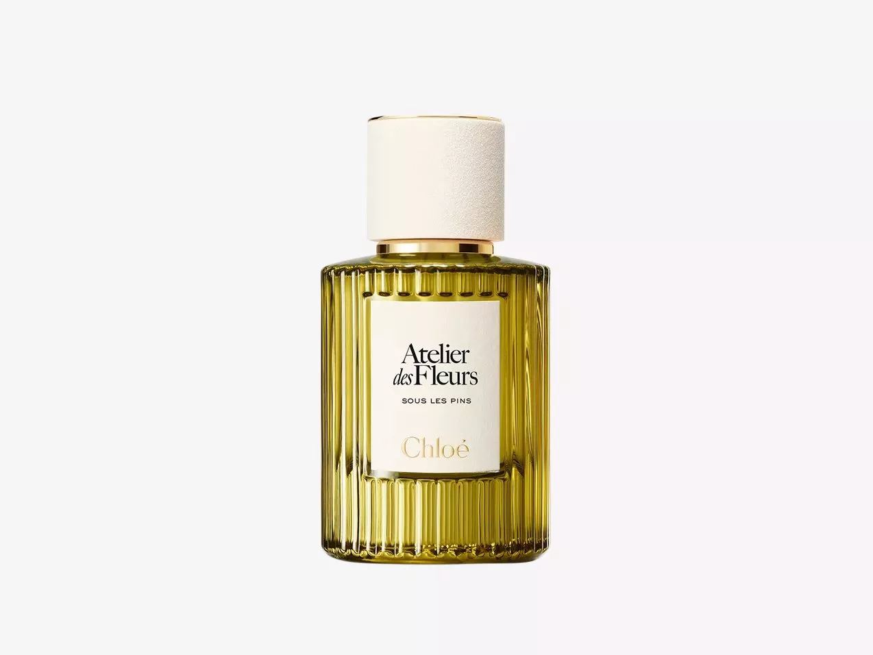 Chloé Atelier des Fleurs Sous Les Pins perfume bottle, ribbed glass with white cap on plain background