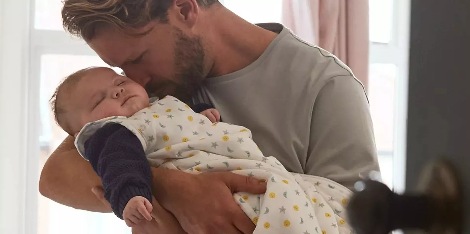 Father holding sleeping baby
