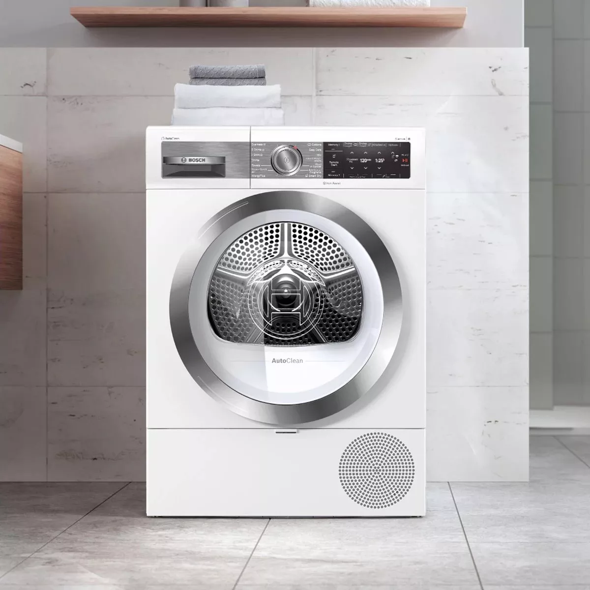 Bosch white front-loading tumble dryer with AutoClean, modern bathroom setting and digital control panel view