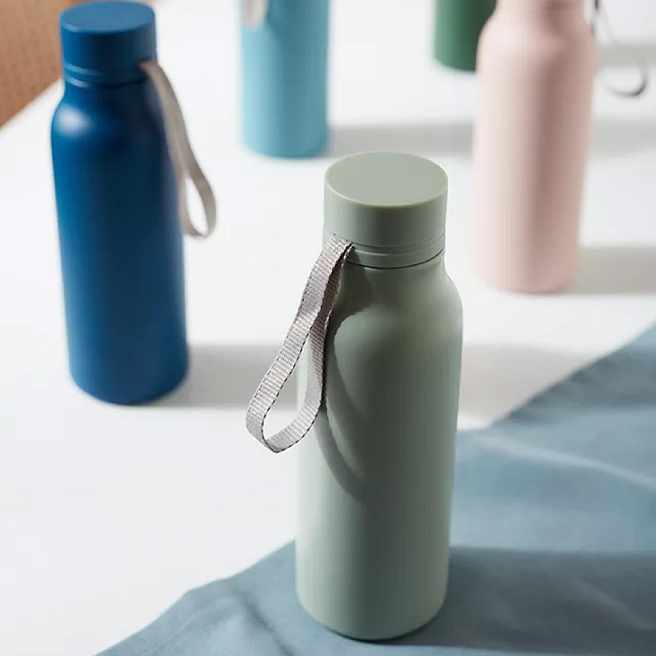 Table with different coloured water bottles