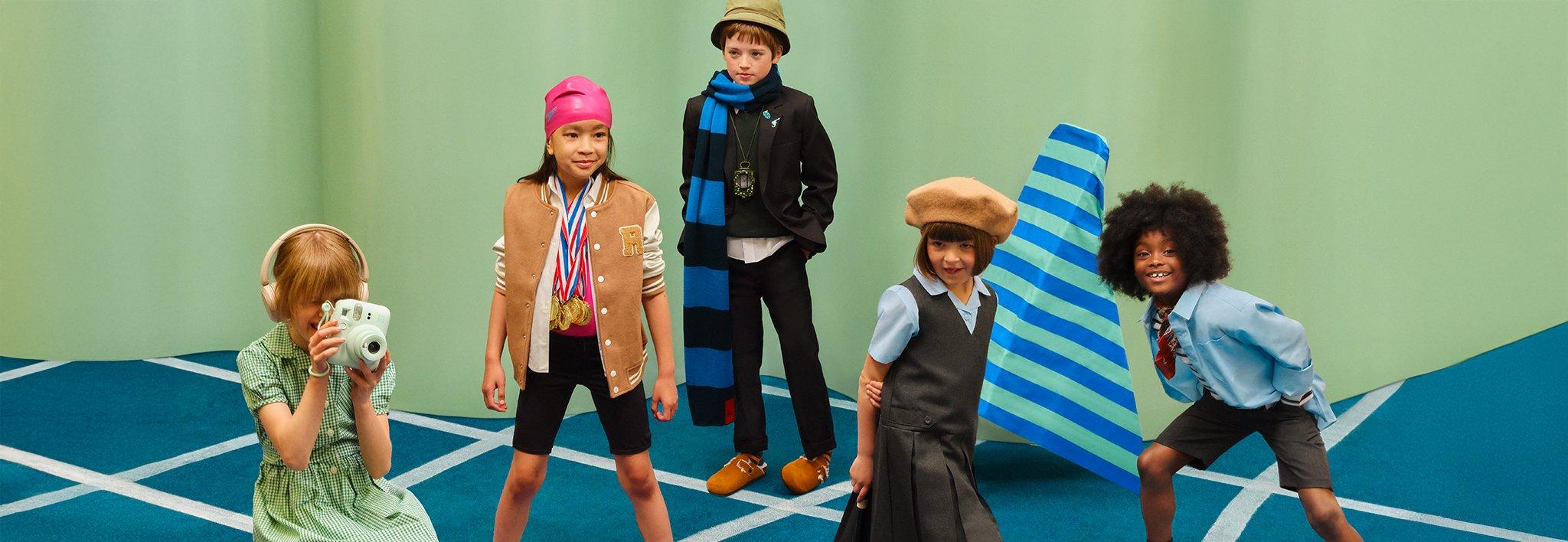 back to school, five children dressed in various themed costumes posing playfully