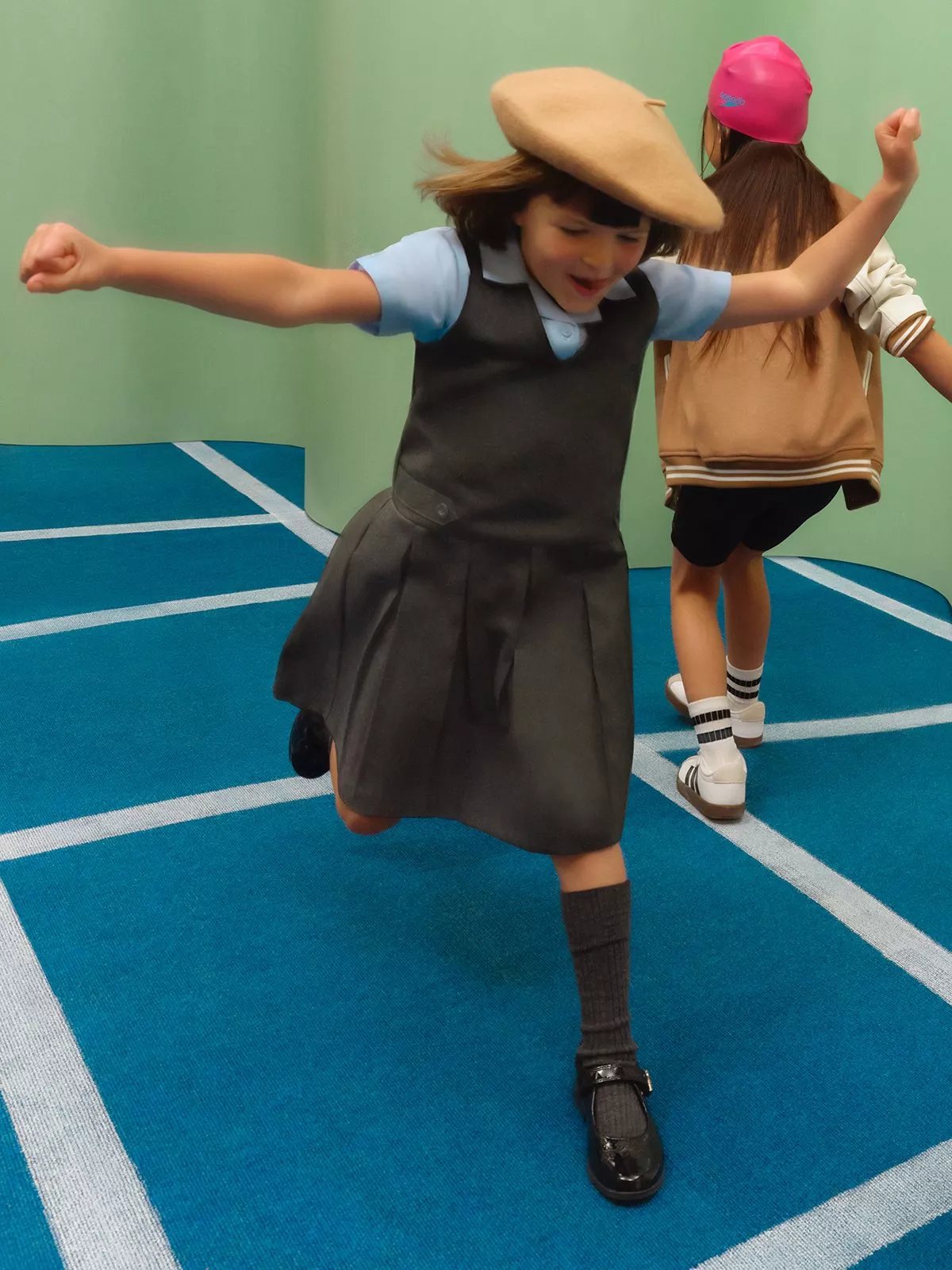 girl jumping wearing a dark dress with light blue shirt